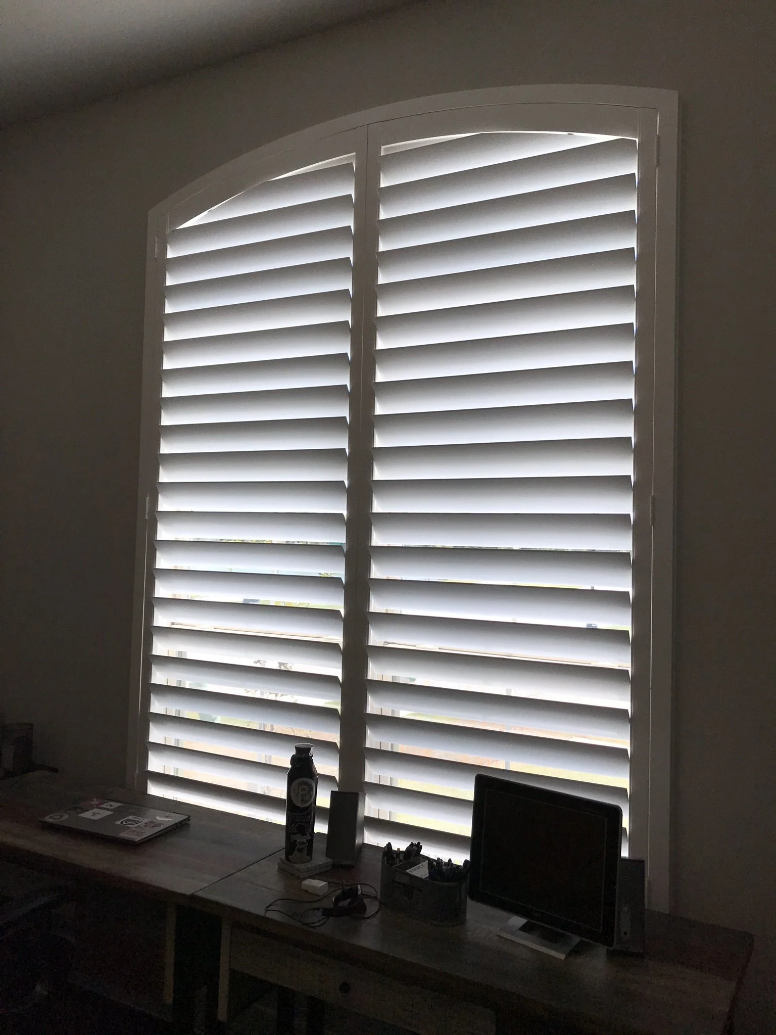 Wood shutters with rear hidden tilt, 4 1/2" louvers, SW Pure White, no divider rails.  Eyebrow arch top.