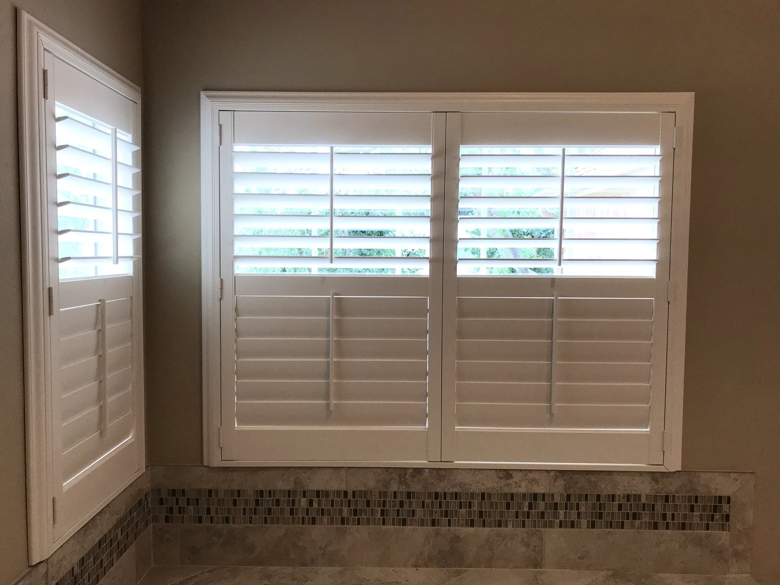 Hunter Douglas Palm Beach Polysatin Vinyl Shutters, 3 1/2" louvers, White Silk, divider rails, front tilt rods, Colonial Z frame, 1 panel and 2 panels, faux shutters.  Opened above divider rail.