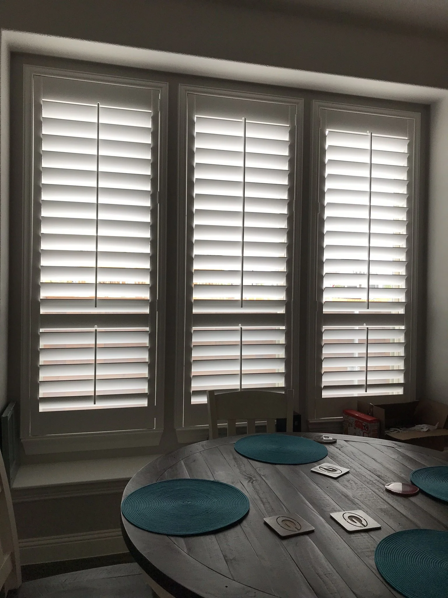 4 1/2" louvers, wood shutters with tilt rods, divider rails at sash, painted.