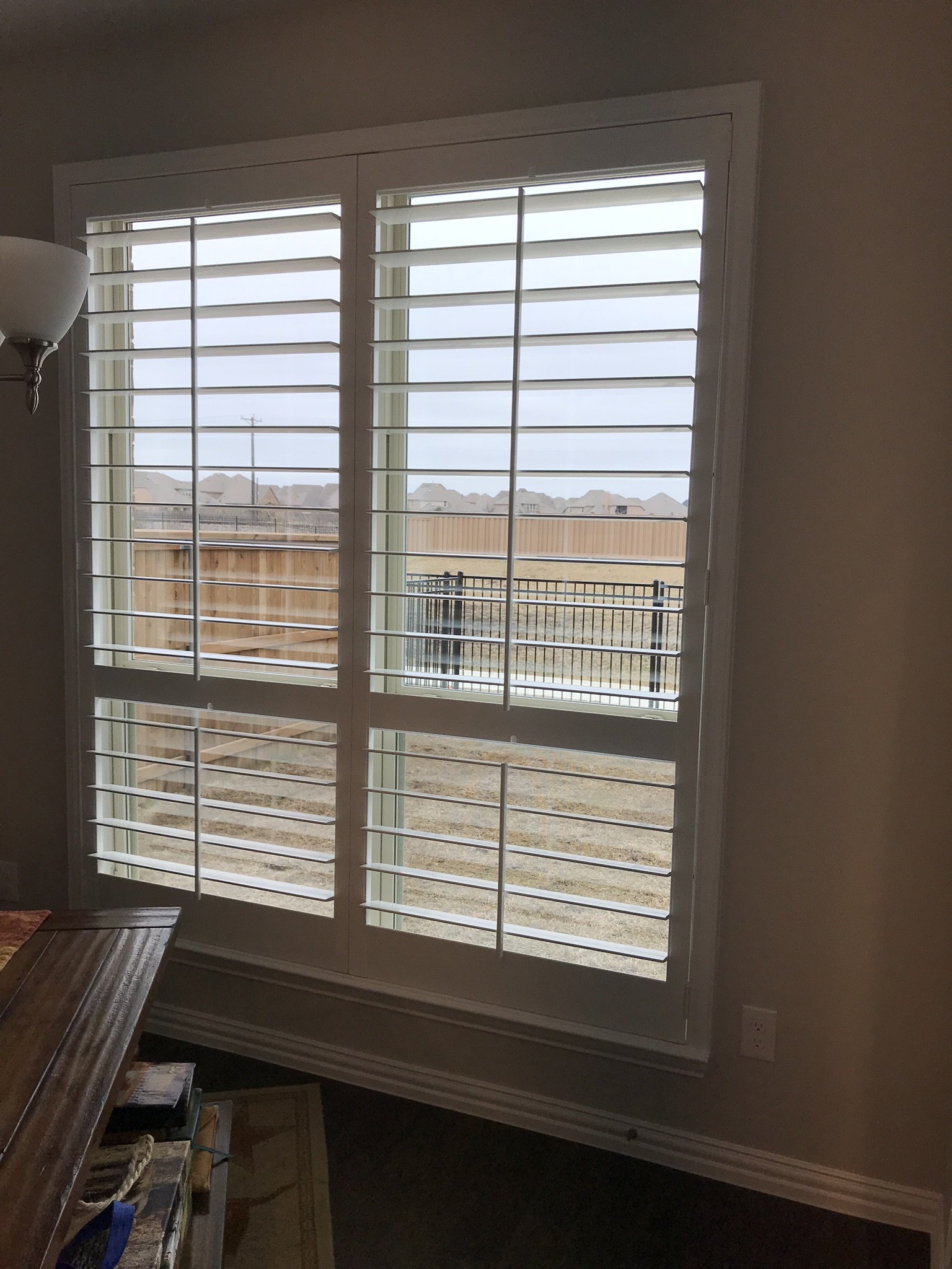 Wood Shutters with tilt rods, painted white, flat master frame, divider rails, 2 panels.