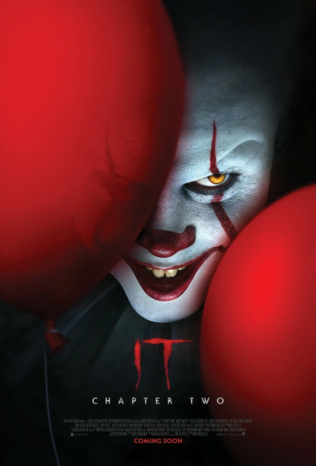 A creepy clown face with white makeup, red makeup around the mouth, nose, and eyes, with a red line running down the forehead. The face has a sinister smile, showing yellowish teeth, and one eye is visible with a yellow iris. Part of a red balloon is