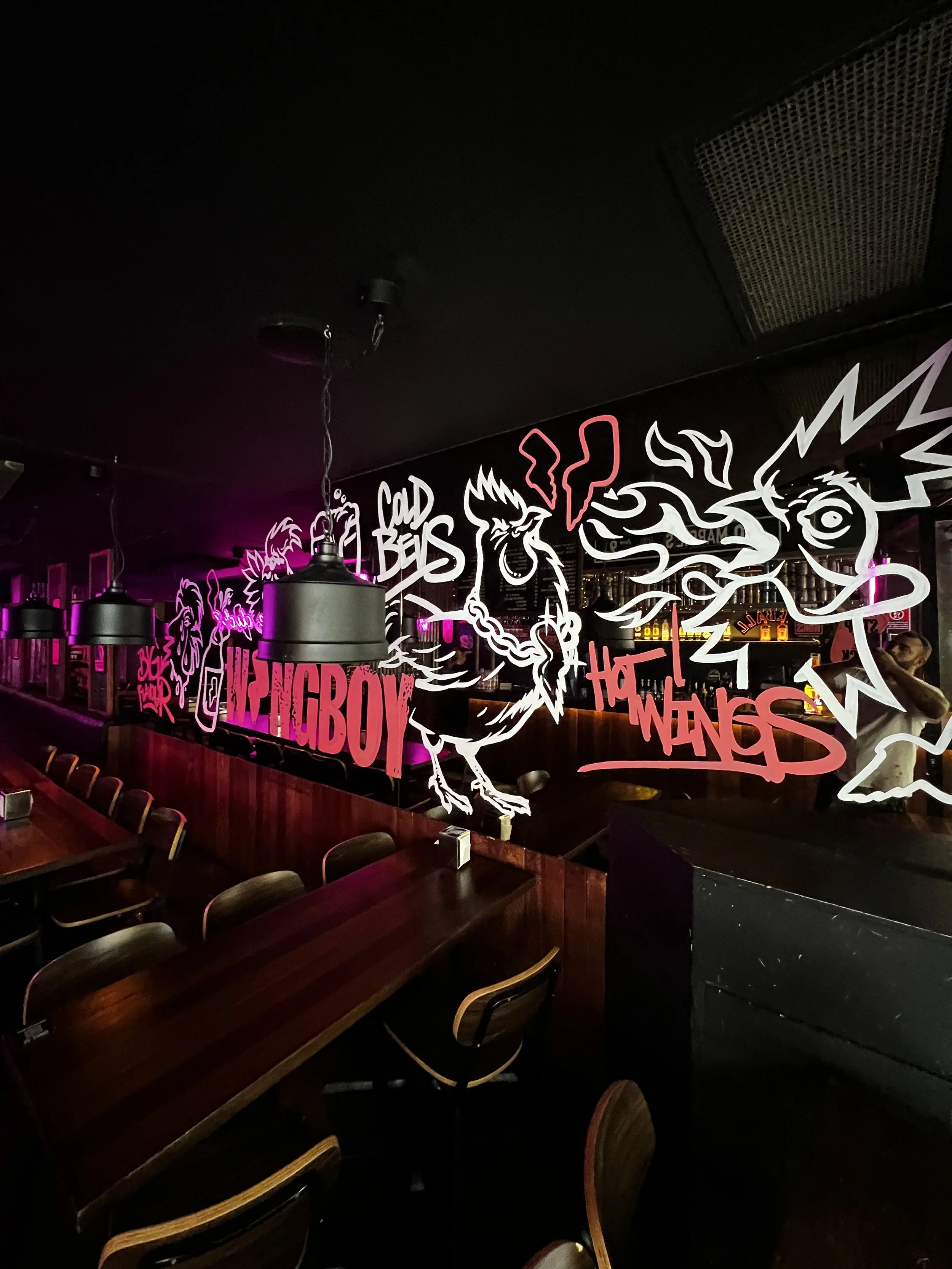 Hand Painted Mural for Wingboy Sydney Graffiti Style Artwork on Mirror in Sydney Resturaunt, Black white and pink on a neon and black background