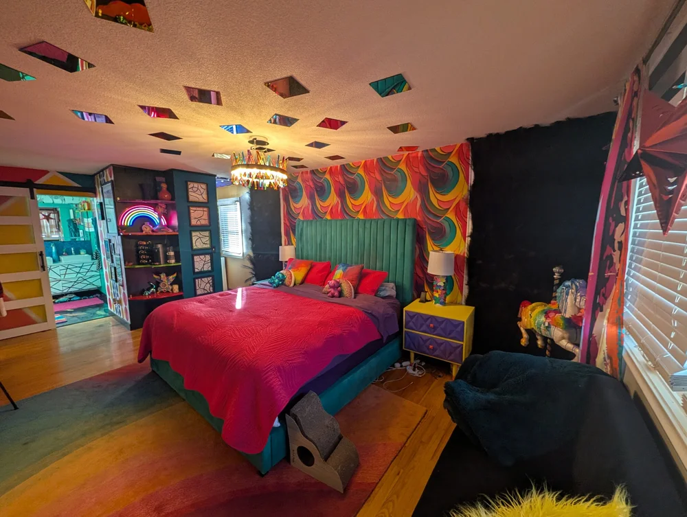 Prism Suite bed under a mirrored prism ceiling