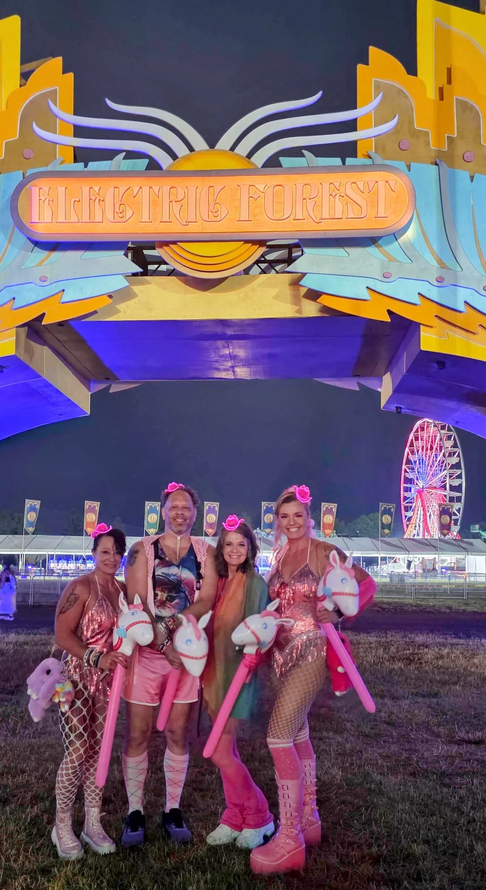 A squad in matching pink festival costumes at EDC Las Vegas