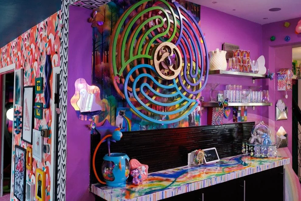 Purple bar wall with disco balls and iridescent shelves