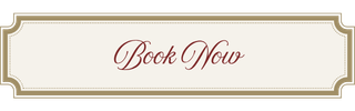 A sign with the text 'Book Now' in elegant cursive font on a beige background, framed with a decorative border.