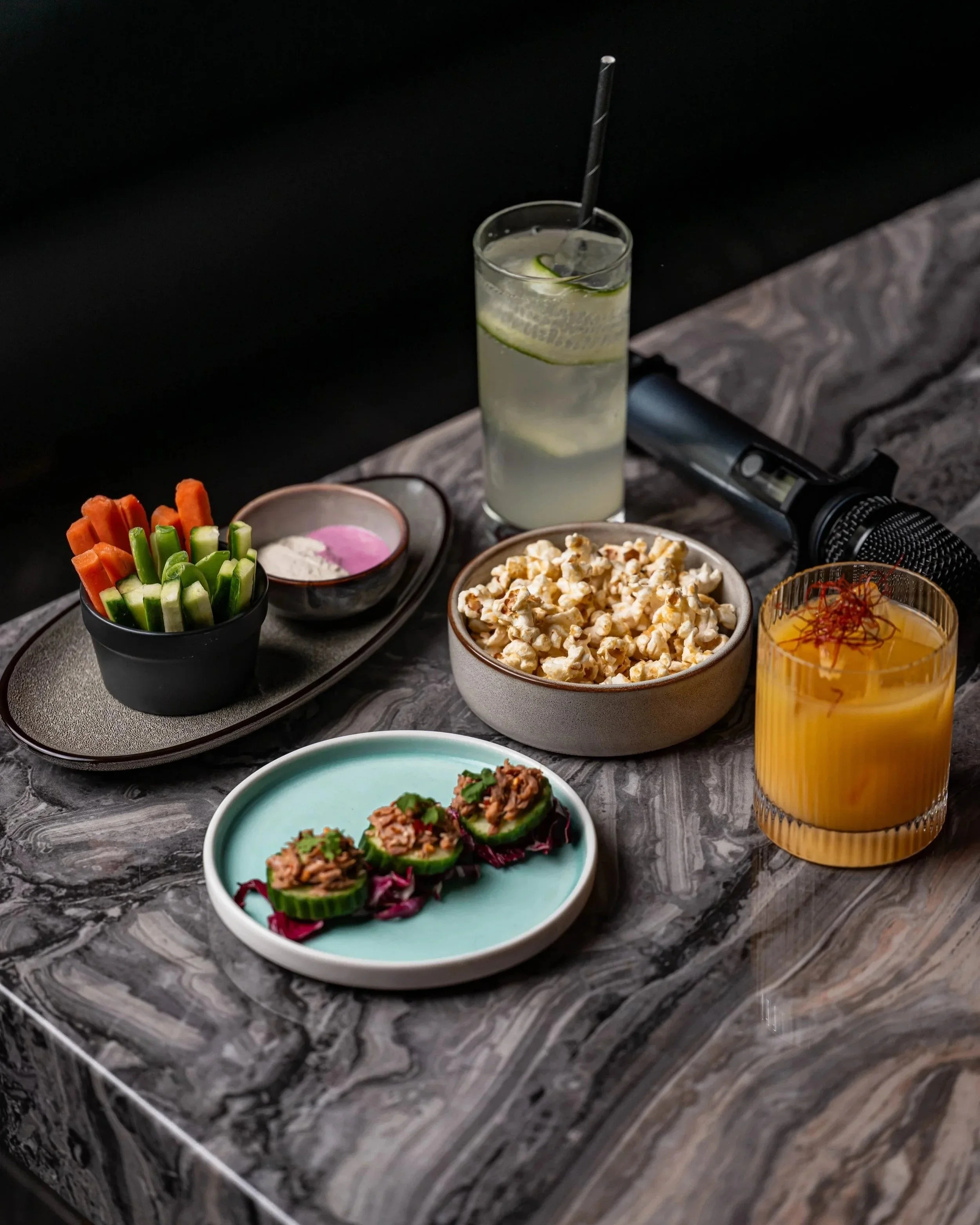 A marble table with our Wellness Edit superfoods and functional cocktails.