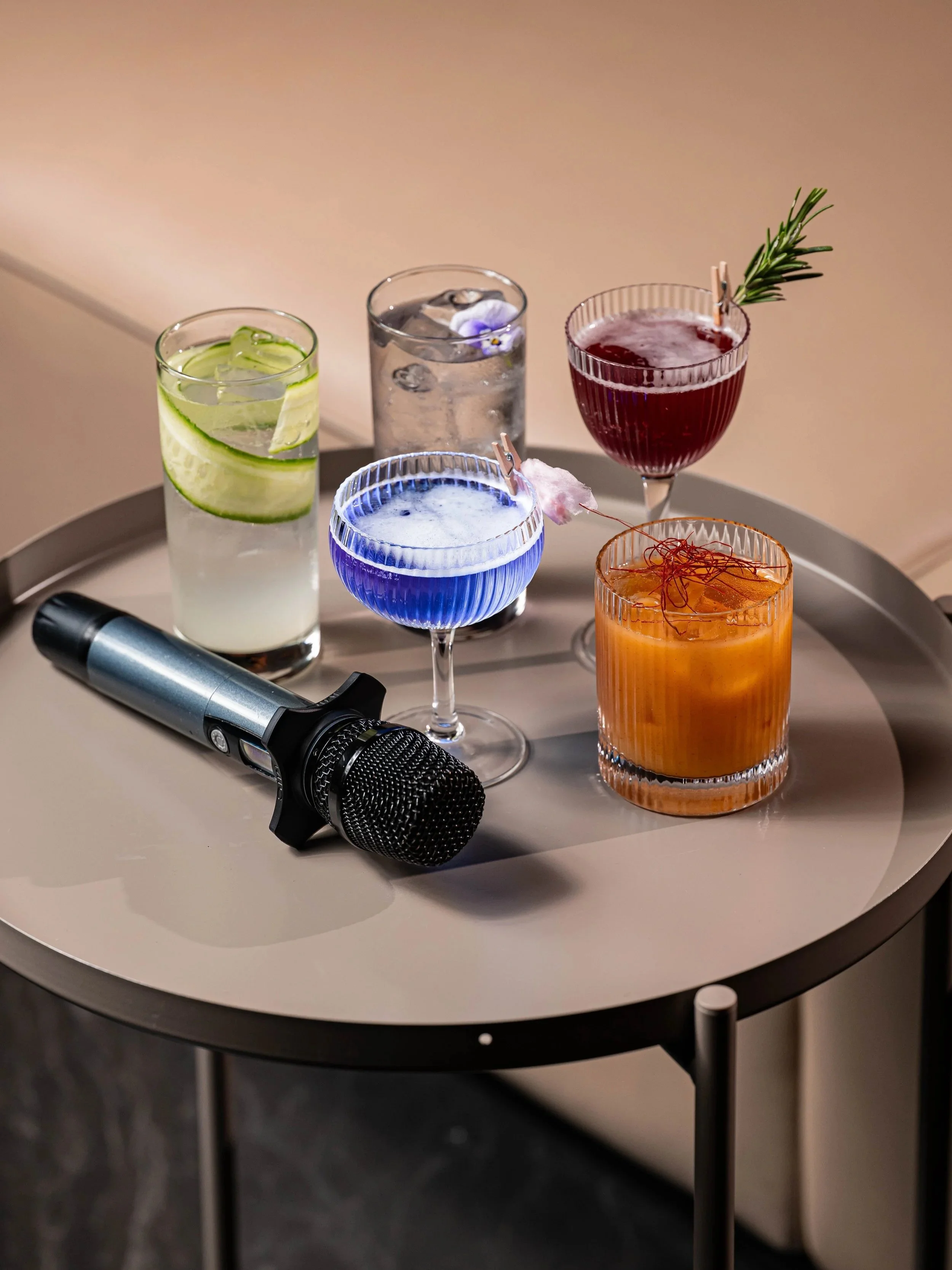 A microphone and 5 of our Wellness Edit cocktails
