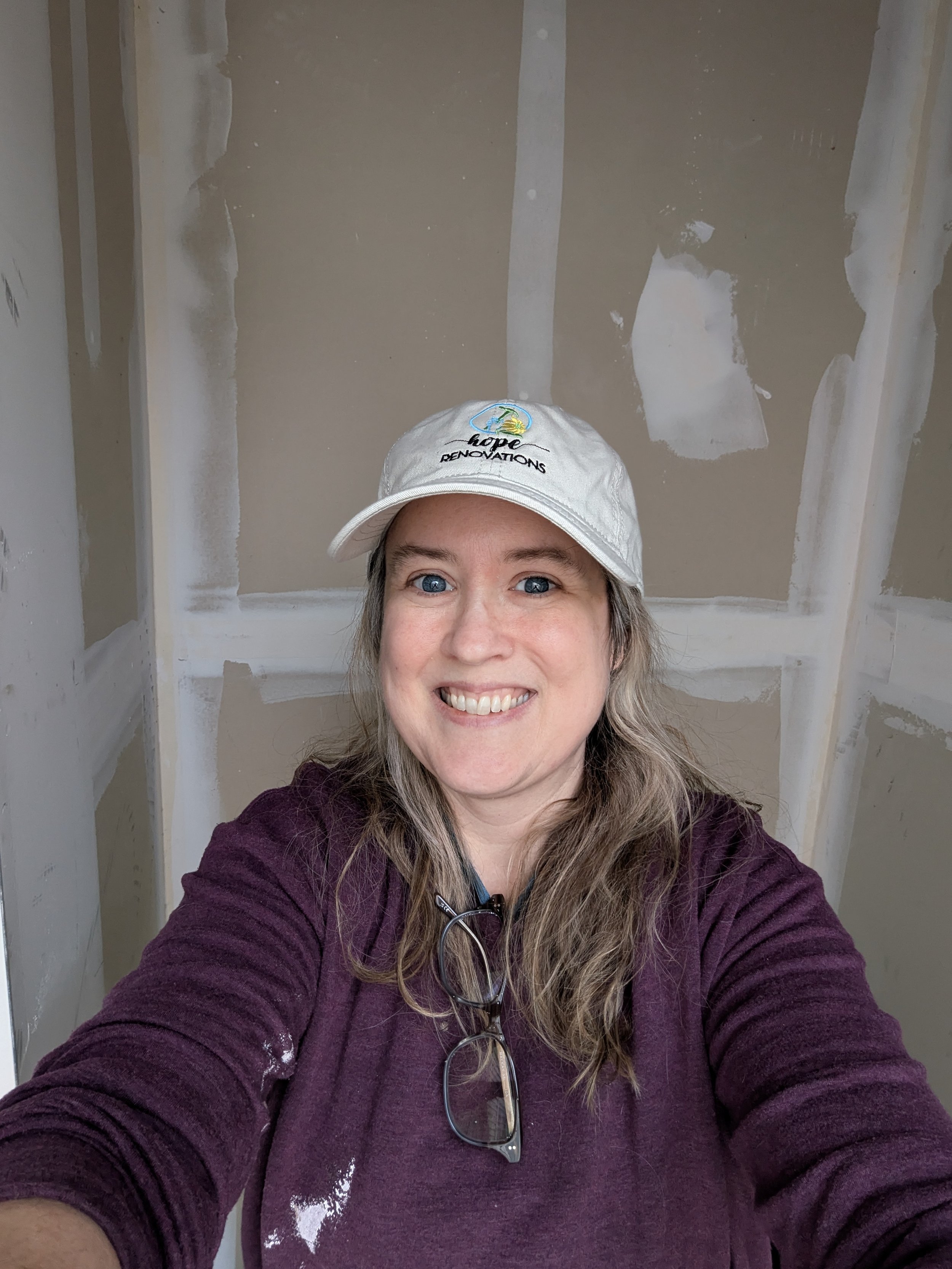 Leigh Carey, the owner of Leigh Drywall Repair in front of sheetrock in Durham, North Carolina