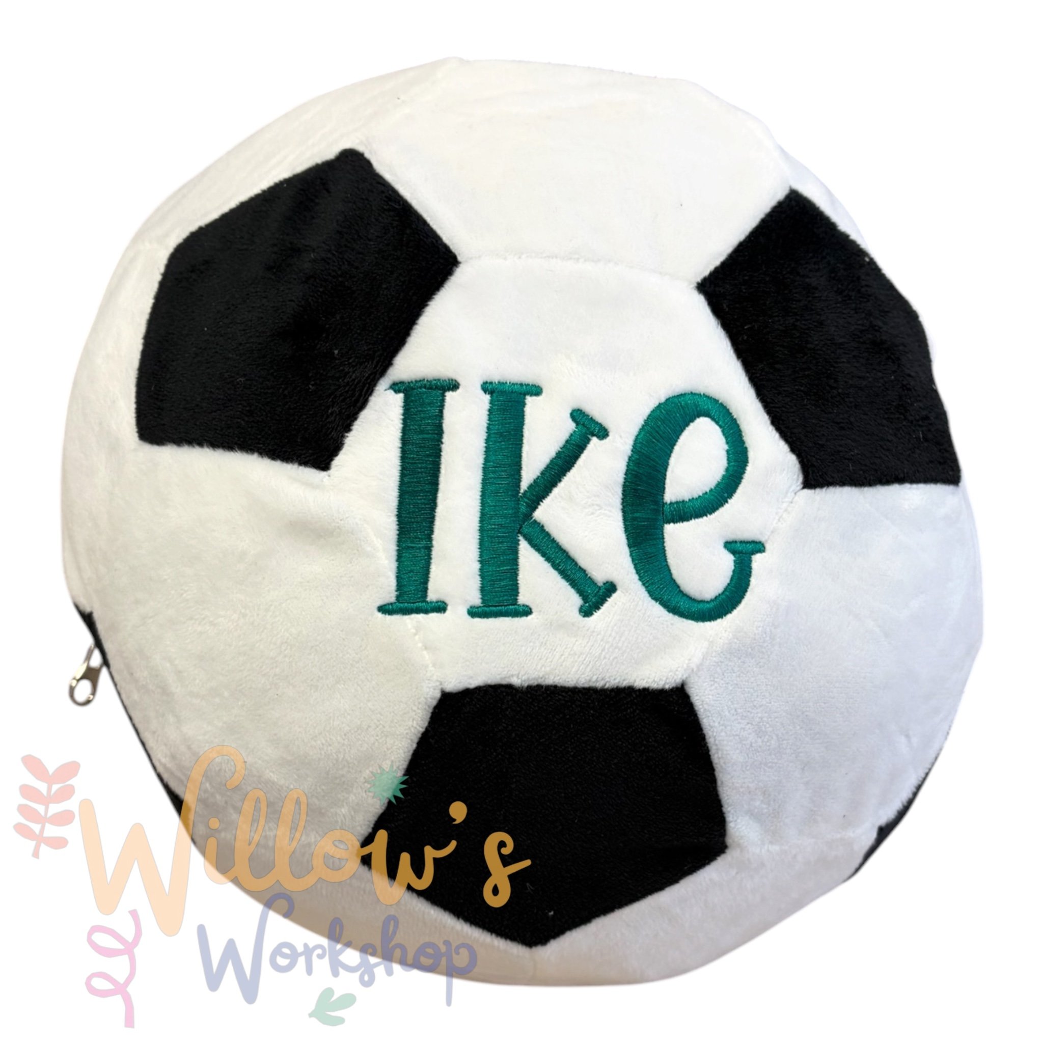 Close-up of a plush toy resembling a soccer ball with embroidered text.
