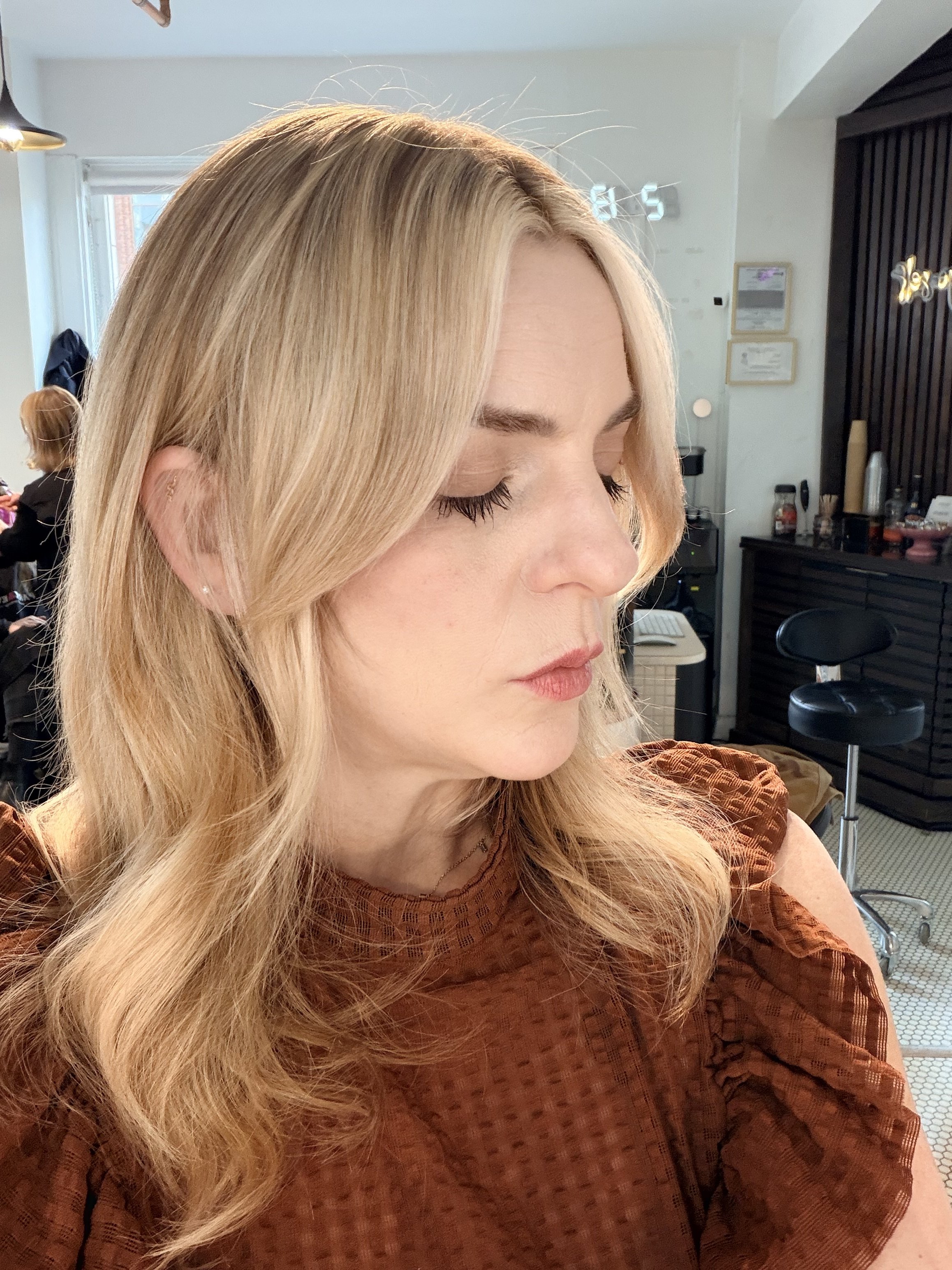 Face-framing fringe trim with soft curtain bangs and blended layers