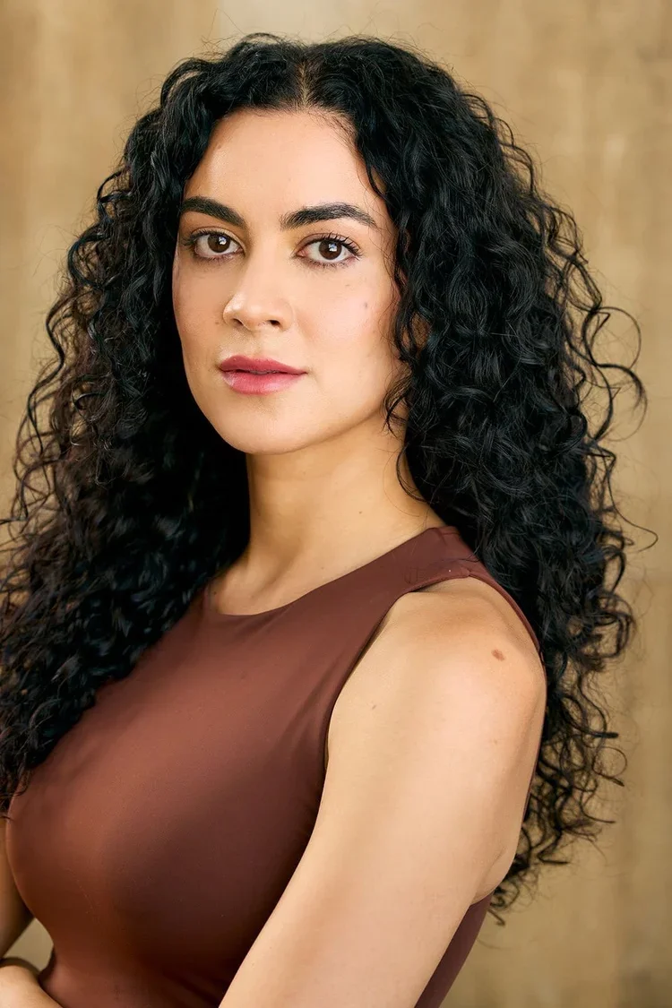 Person with natural curly hair after a curl specialty haircut