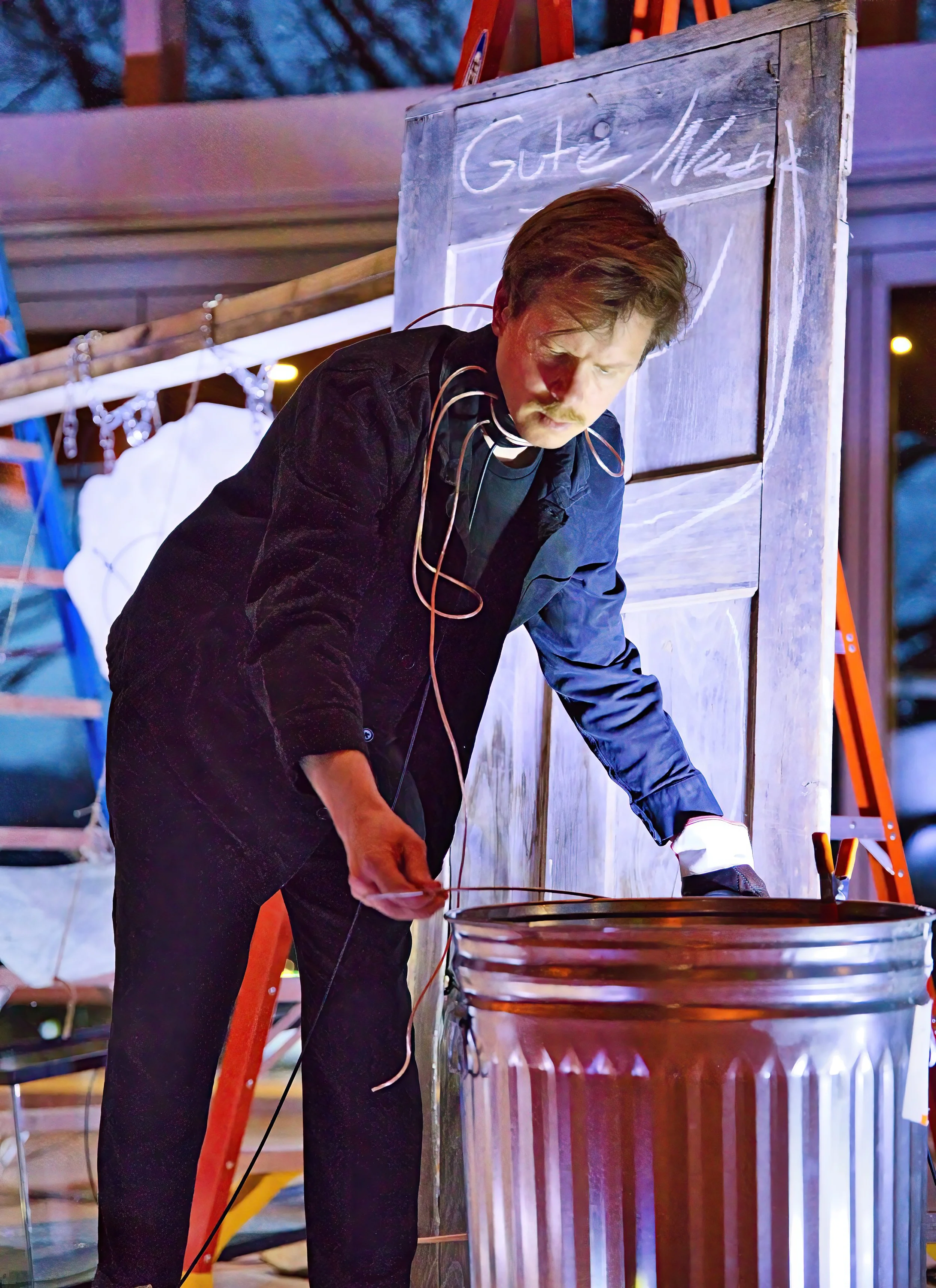 Oil barrels and trashcans have featured in the installation. Here the trash can, it is being touched b a metal rod that follows the same principle as "the tree"
