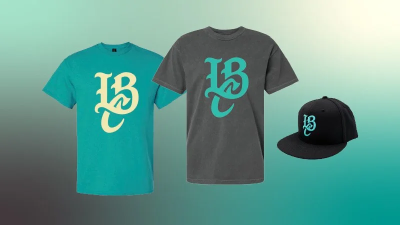 Two Long Beach Coast t-shirts and a Long Beach Coast hat. All have the Long Beach Coast logo mark (the letters L, B, and C)