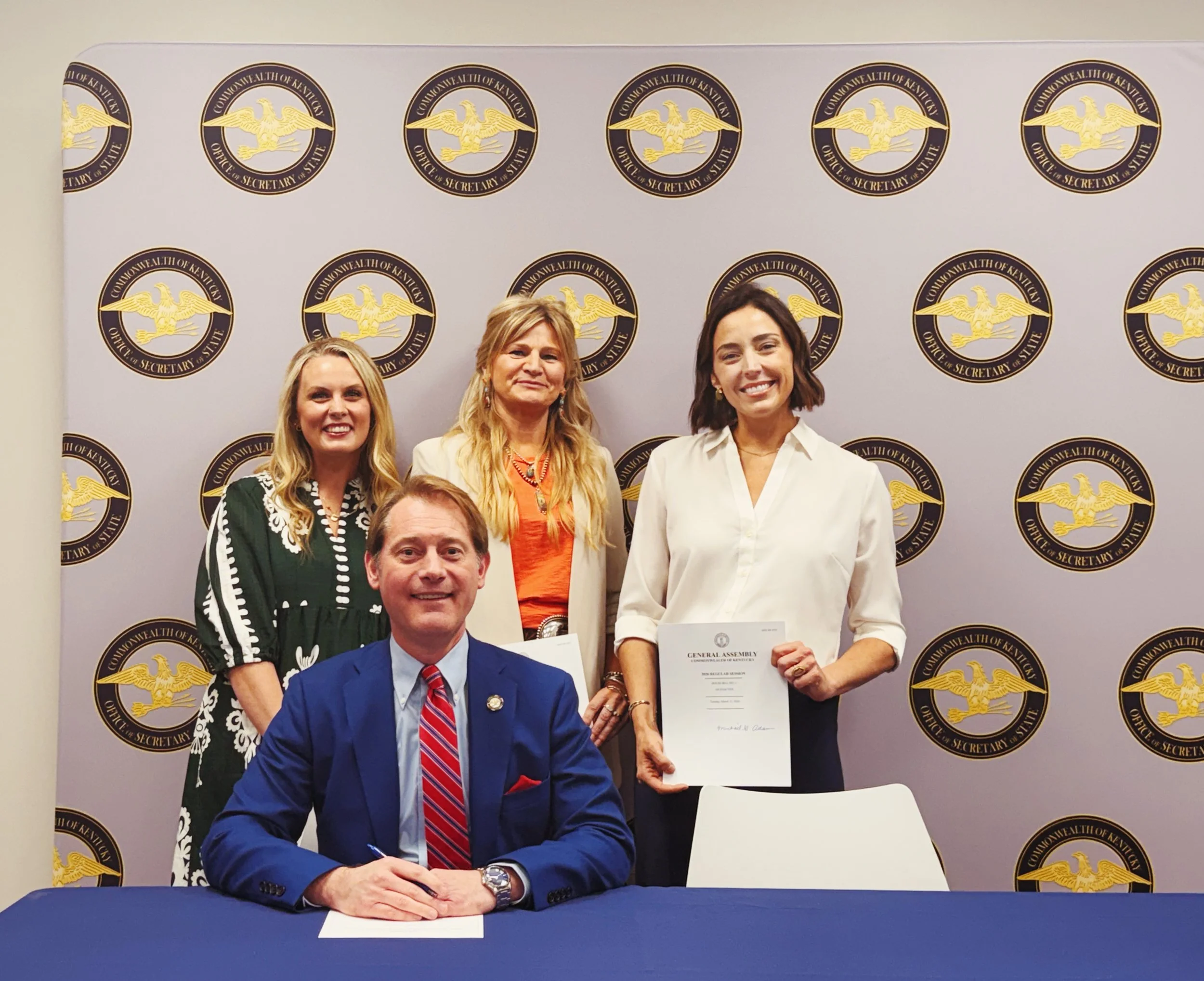 Public signing ceremony for House Bill 4, legislation criminalizing grooming behavior in Kentucky. Pictured: Laura Wills-Coppelman, Hayley Weddle, Tracy Tuminnello, and Representative Marianne Proctor.