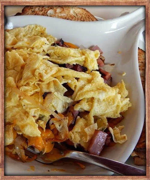 Scrambled eggs with hashbrowns, ham, bacon and cheese mixed in.