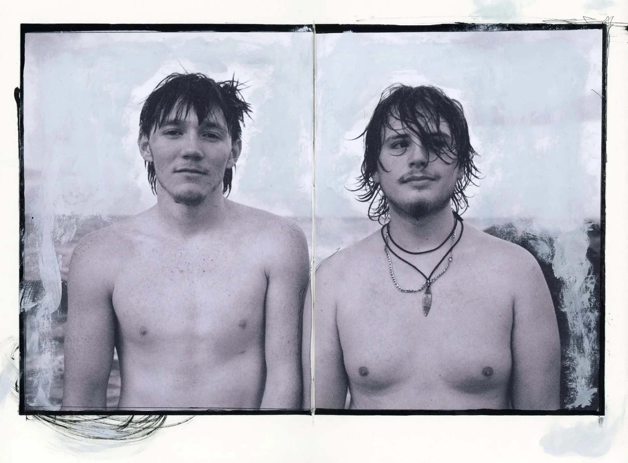 Black and white photo of two shirtless young men with wet hair standing outdoors, facing the camera, with a cloudy sky in the background.