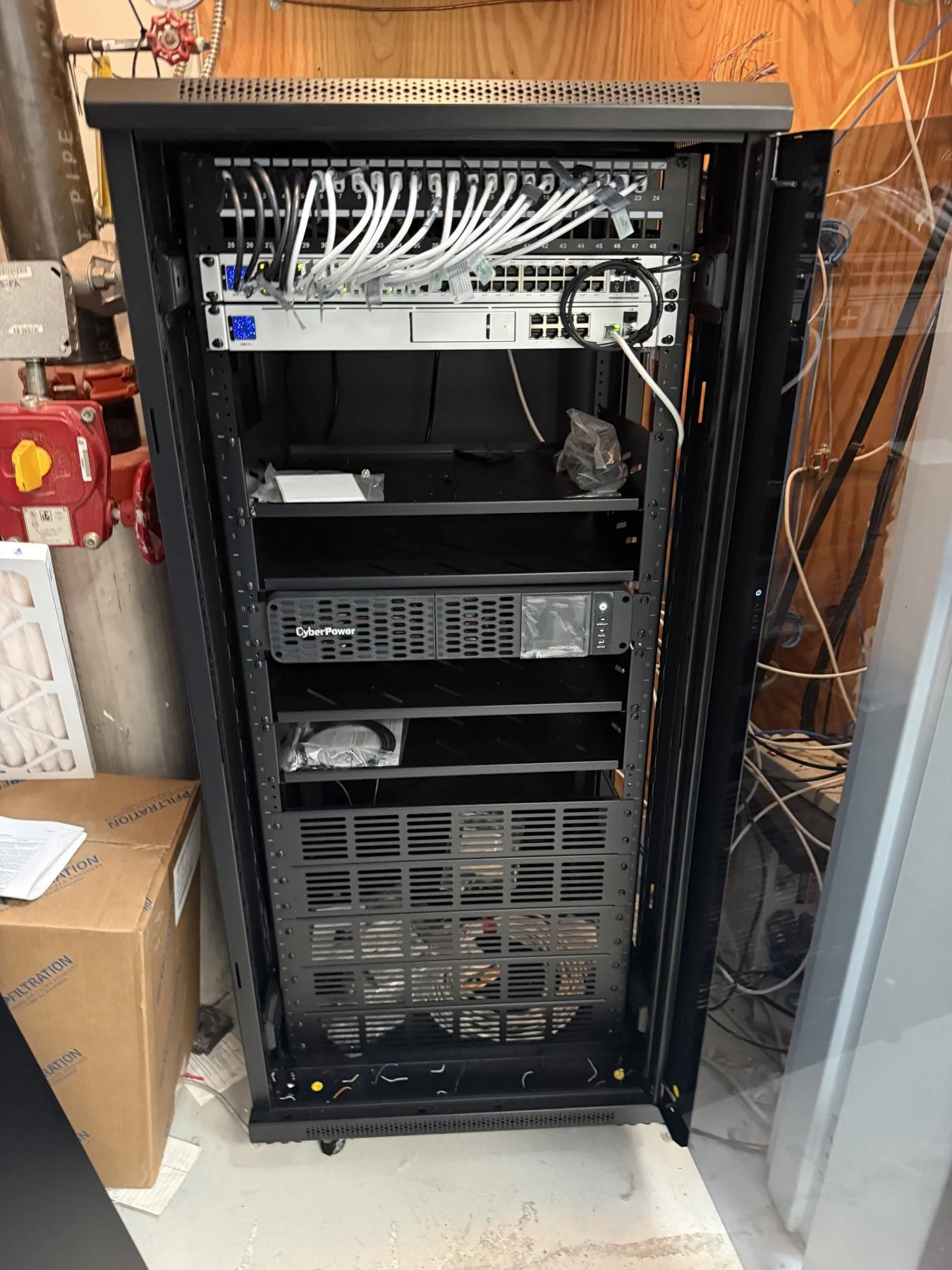 Larger MDF network rack with Ubiquiti switching, patch panels and battery backup in a Bold City commercial network project