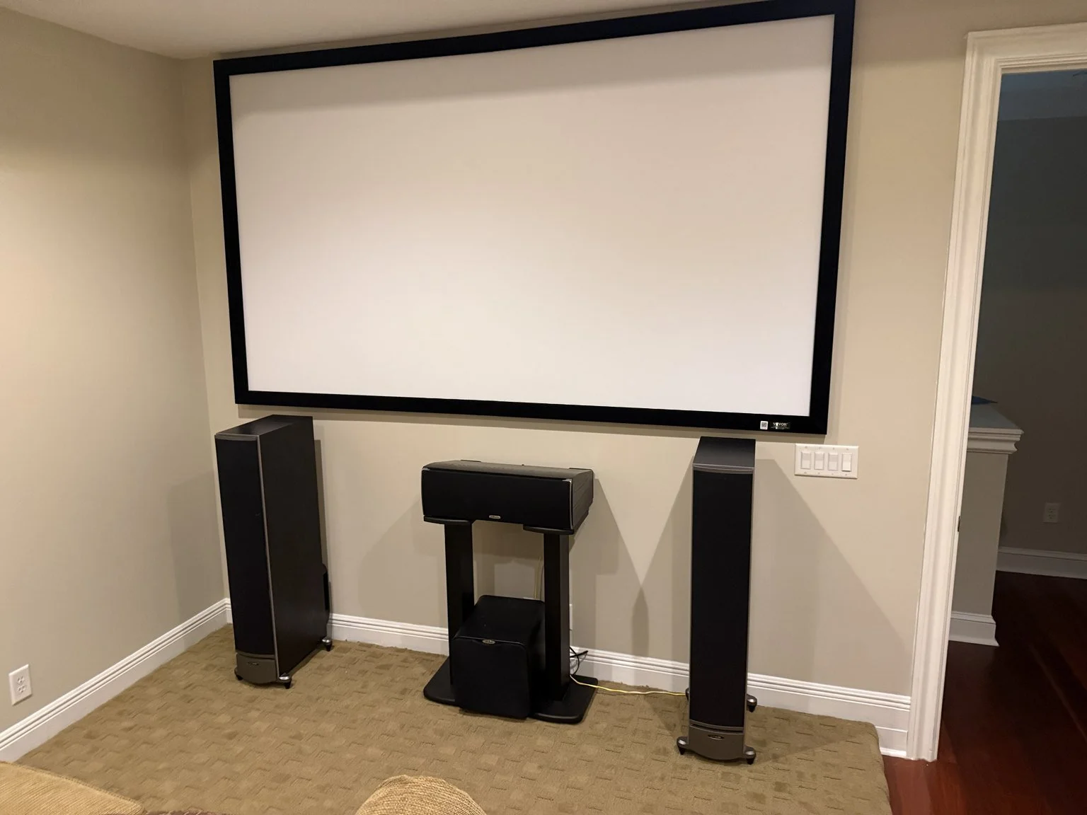 Projection screen in the Amelia View home theater upgraded by Bold City
