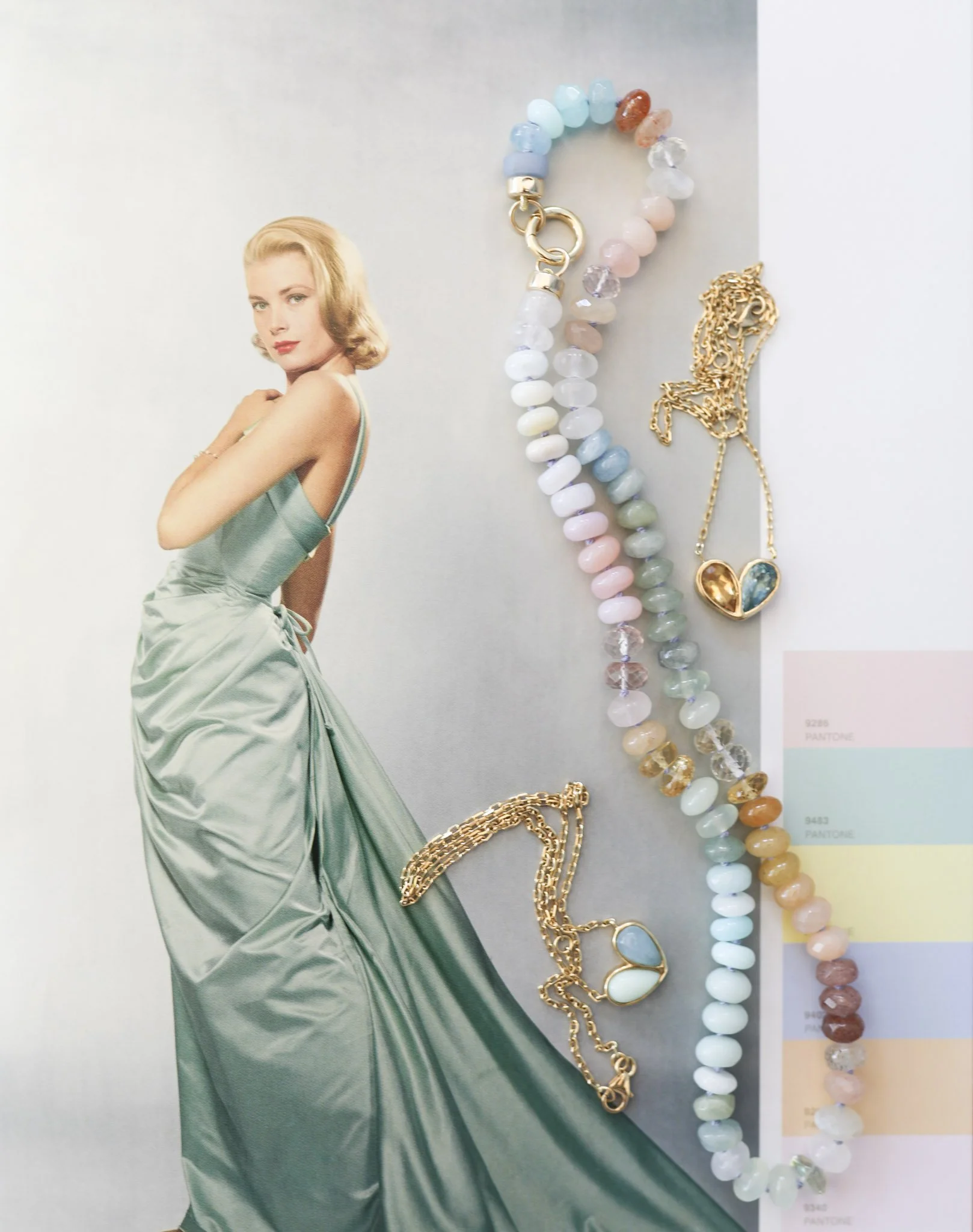 A vintage fashion magazine page featuring a woman in a satin gown, alongside a colorful beaded necklace, gold chain with pastel charms, and a gold necklace with a pendant, with Pantone color swatches partially visible.