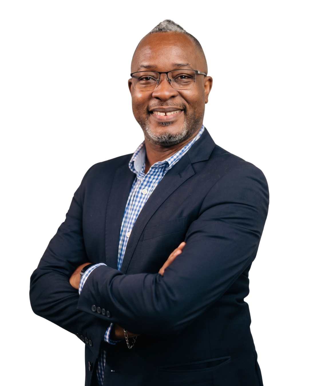 Portrait of a smiling middle-aged man wearing glasses, a dark blazer, and a blue checkered shirt, standing with arms crossed