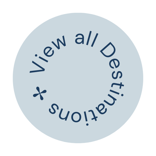 Circular badge with blue background and navy text that says 'view all Destinations' in a circular layout.