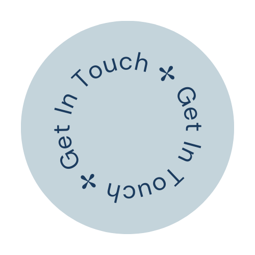 A circular light blue button with dark blue text that reads 'Get In Touch' repeated twice around the circle, with small asterisks between the phrases.