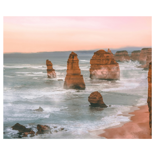 Seaside view of the Twelve Apostles limestone stacks along the Great Ocean Road in Australia during sunset.