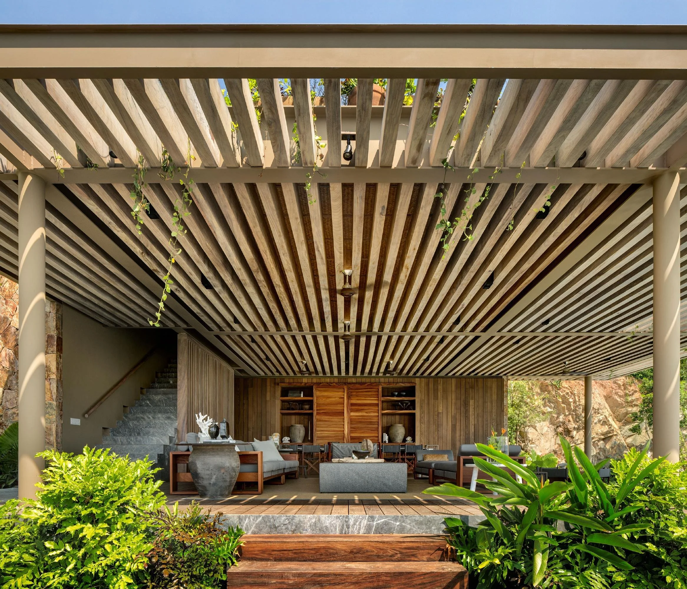 Coastal residence in Mexico with shaded outdoor spaces and materials suited to the tropical environment.
