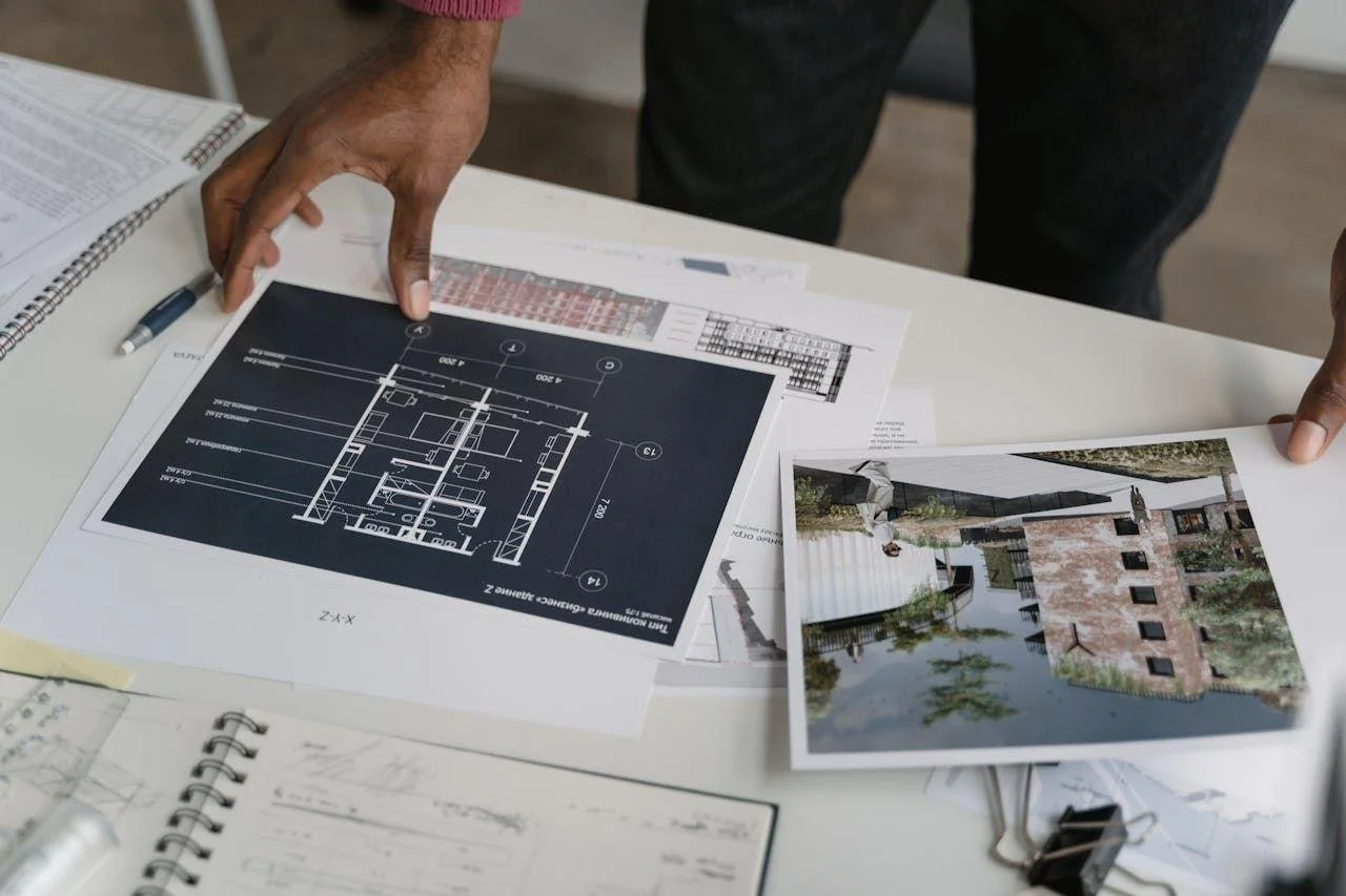 Property documents being reviewed on a table as part of a real estate purchase process.