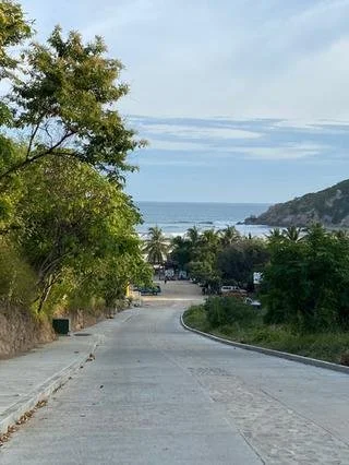 Coastal hillside access route descending toward the beach in Zihuatanejo, Mexico.