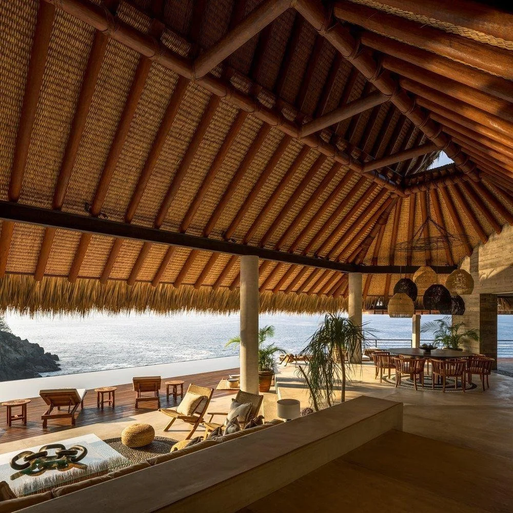 Contemporary coastal architecture in Mexico featuring shaded terraces and indoor-outdoor living.