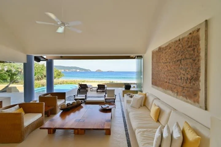 Open living area and oceanview terrace of a coastal residence in Zihuatanejo, Mexico.