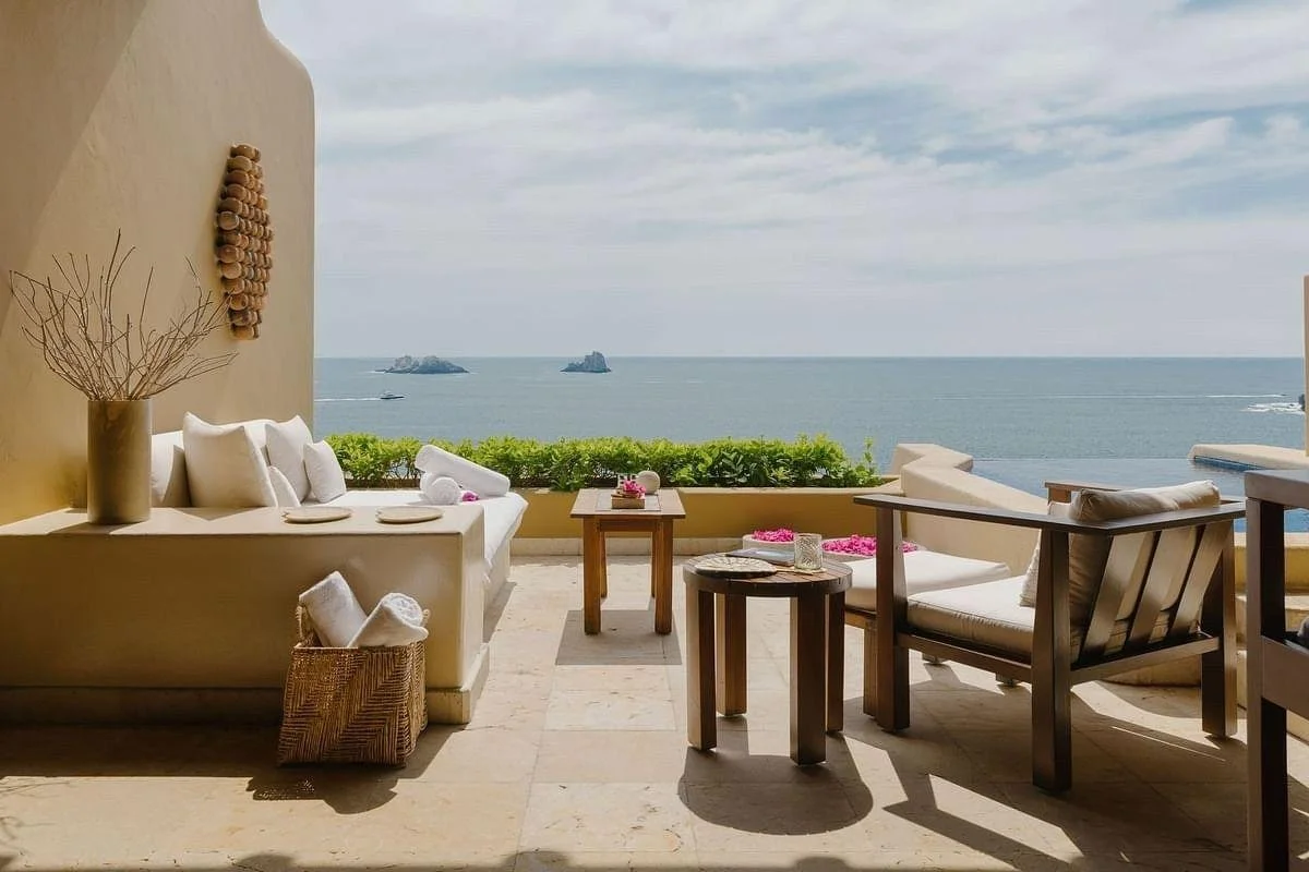 Oceanview terrace of a coastal home in Mexico showing natural light and shaded outdoor living areas.