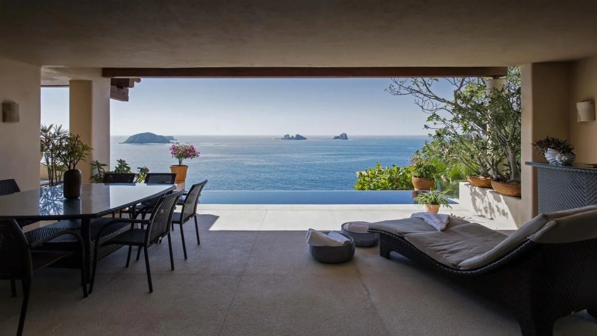 Furnished terrace overlooking the Pacific Ocean from a coastal residence in Zihuatanejo, Mexico.