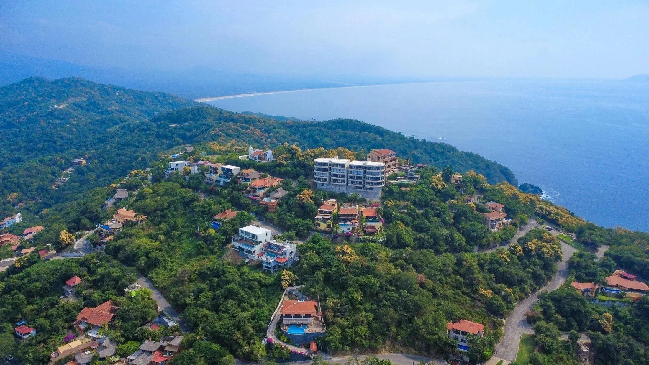 Established coastal residential community in Mexico surrounded by mature tropical landscaping.
