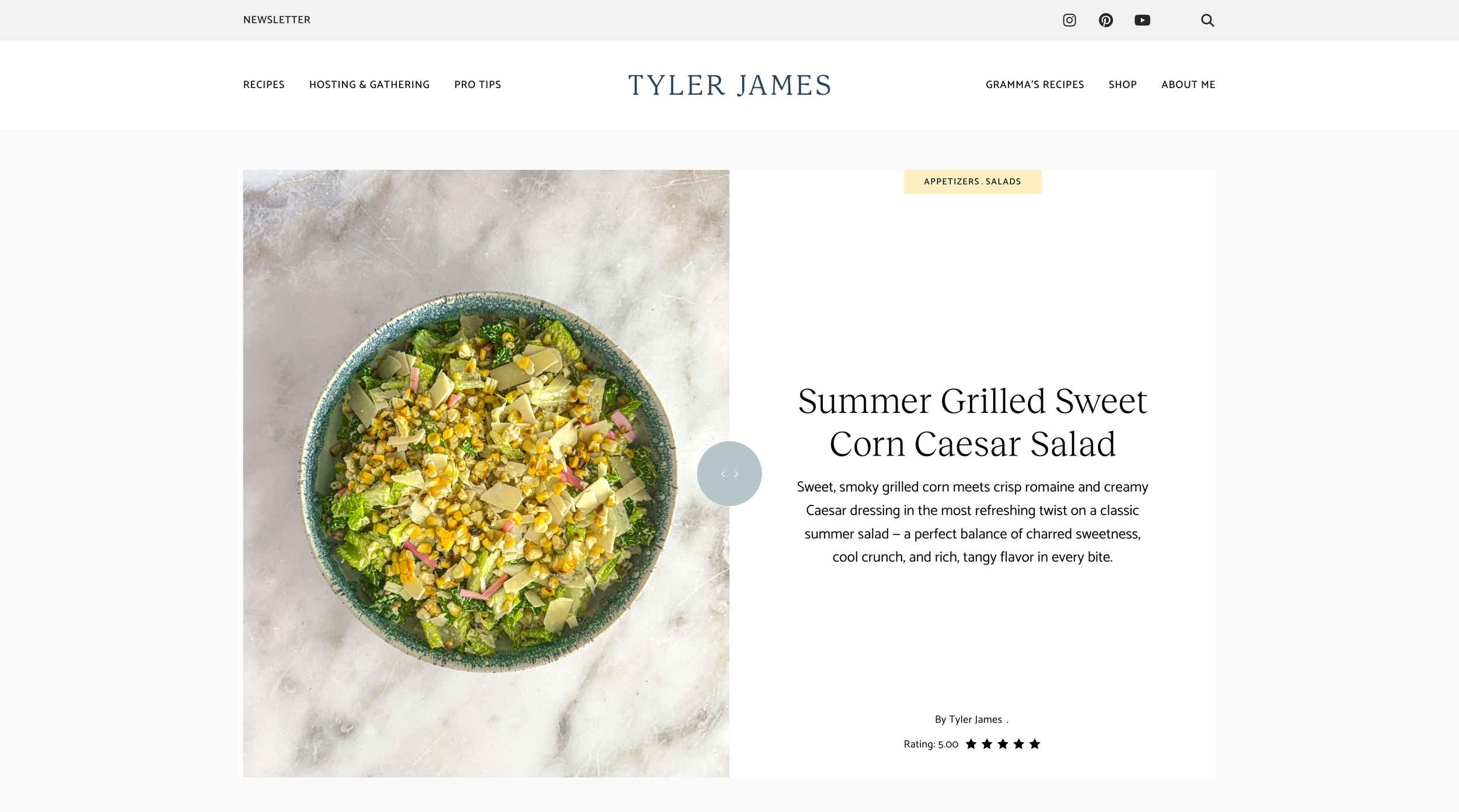 A bowl of summer grilled sweet corn Caesar salad with romaine lettuce, corn kernels, cheese, and pink pickled onions on a light surface.