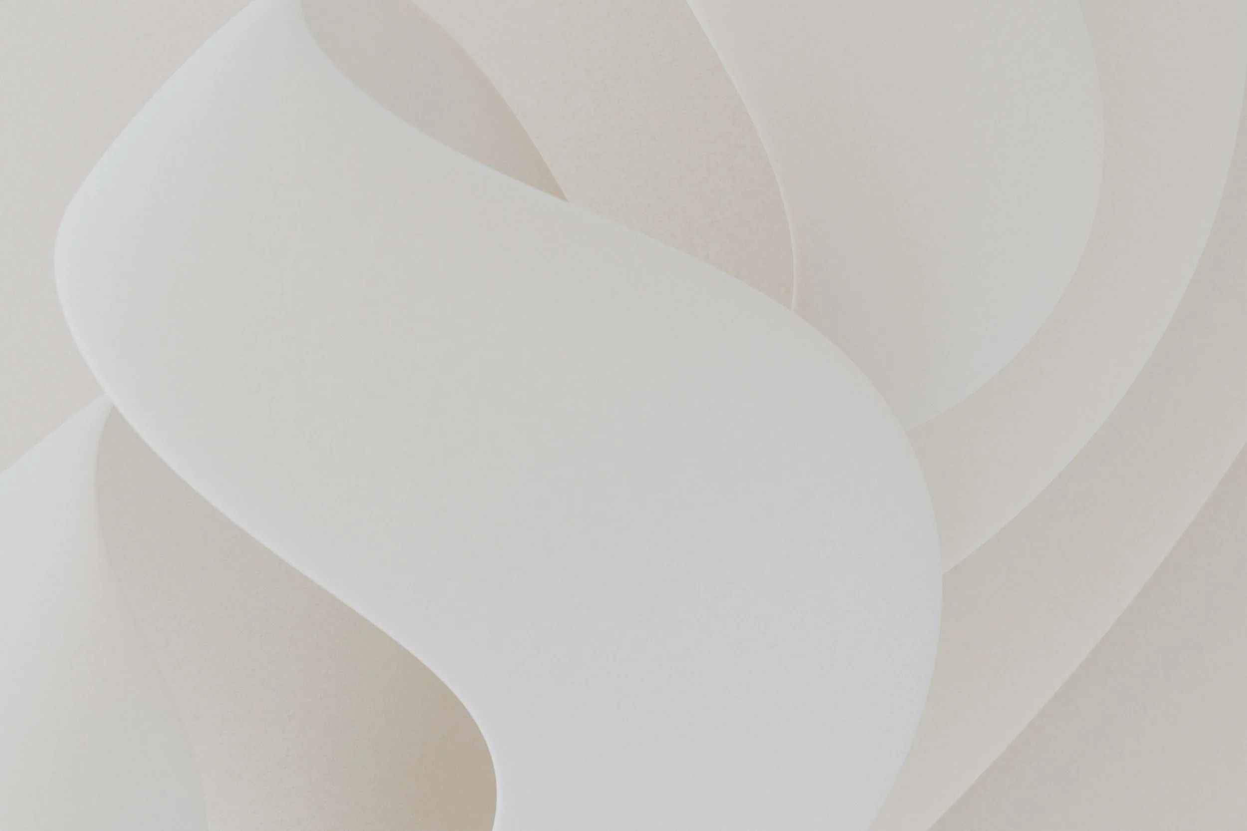 Abstract design with soft, overlapping curved shapes in neutral tones of white, beige, and light taupe.