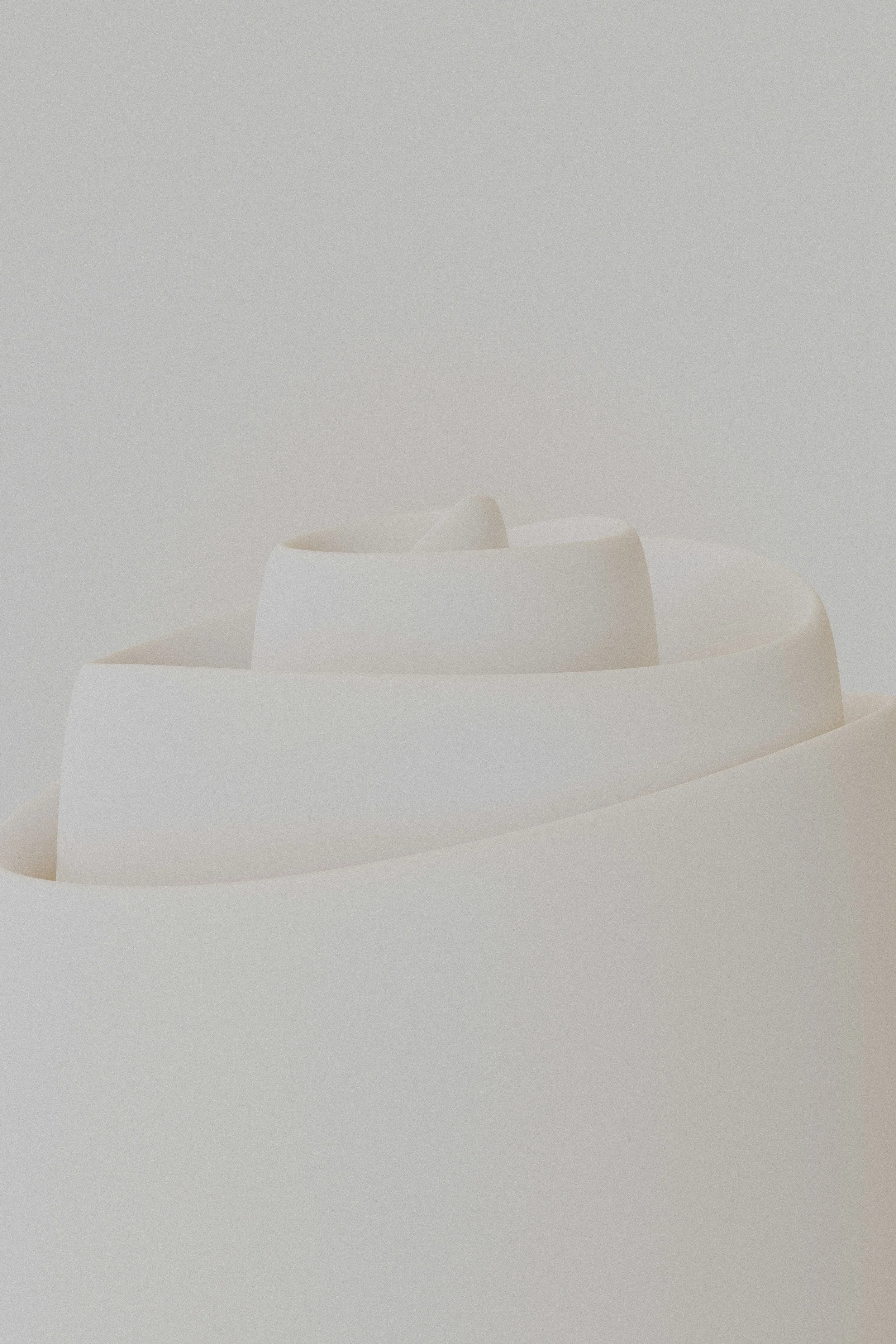 Close-up of a modern, minimalist white sculpture with smooth, curved layers.