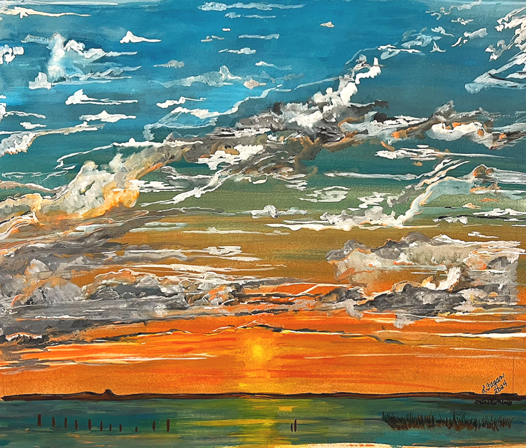 Colorful sunset over a body of water with a partly cloudy sky.