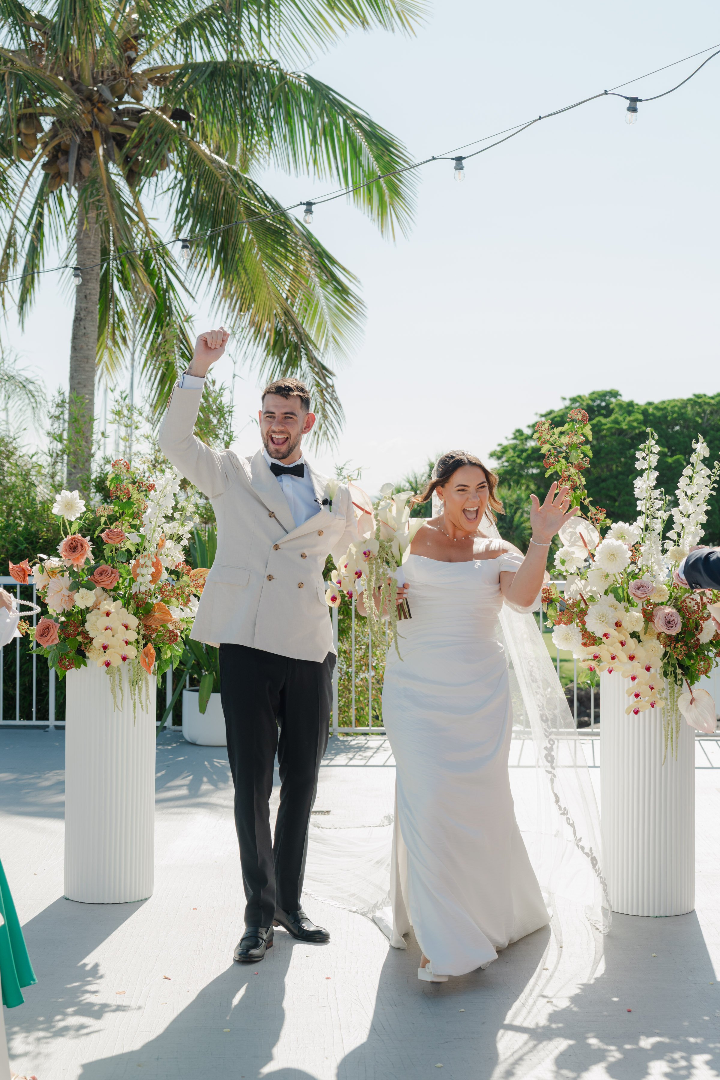 Sunshine Coast wedding florist ceremony flowers with delphinium, orchids, anthuriums and roses