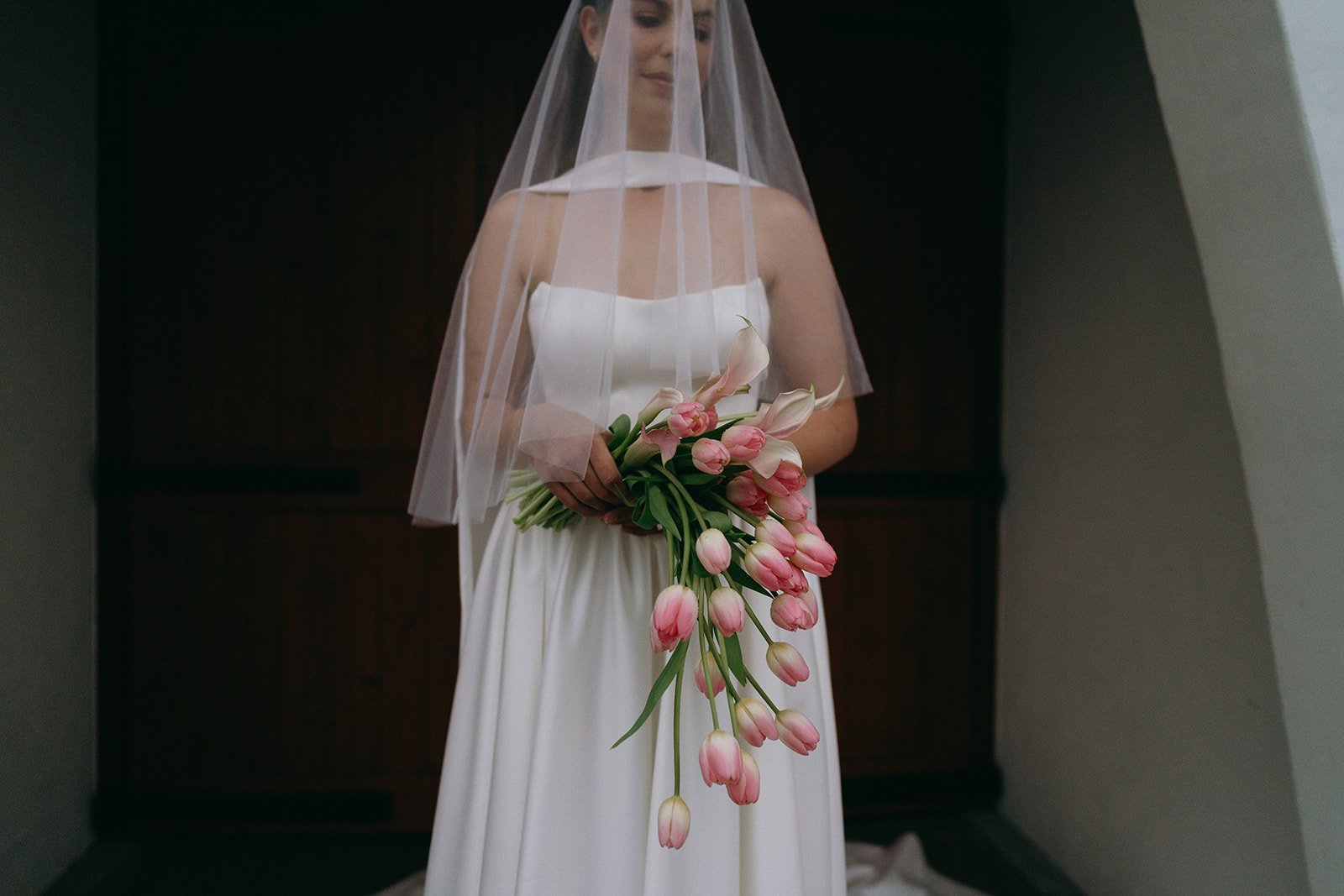 bride holding romantic cascading tulip wedding bouquet made by Noosa florist