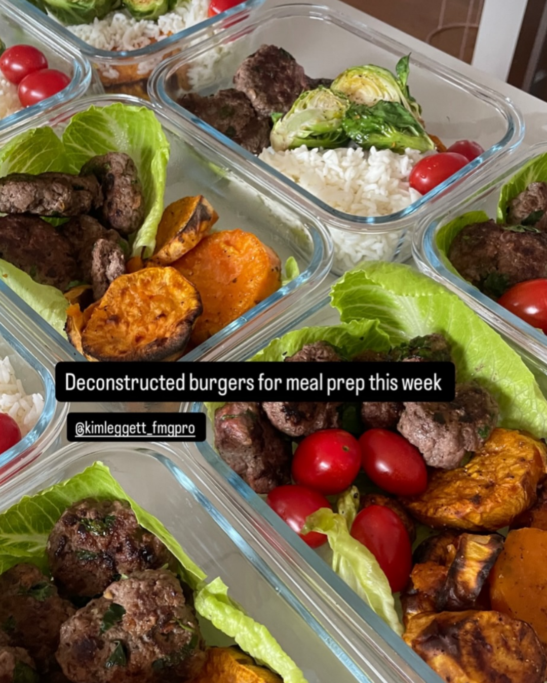 Meal prep containers with deconstructed burgers, cherry tomatoes, roasted sweet potatoes, lettuce, and rice.