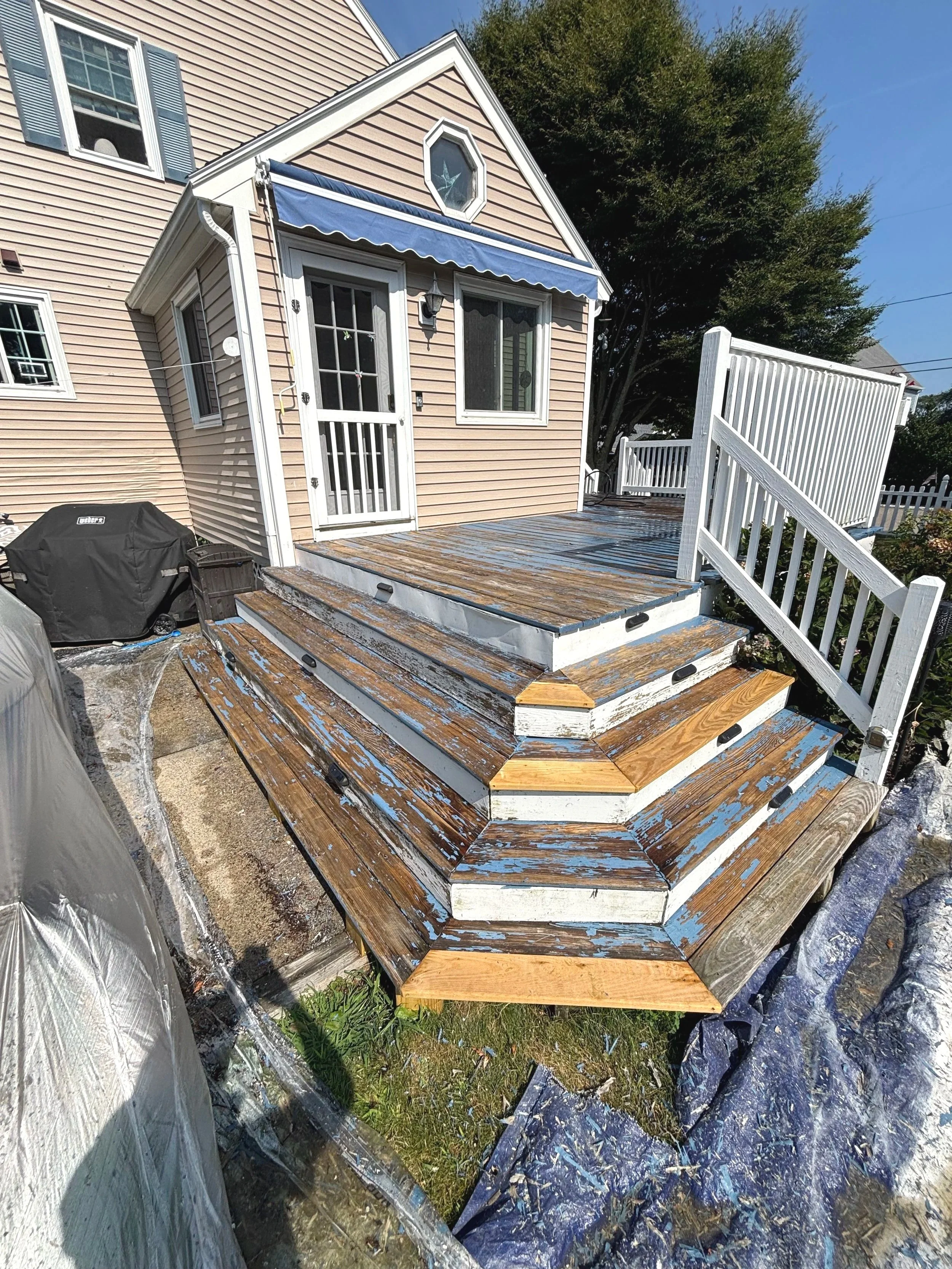 Deck refinishing project in Massachusetts. Sanding and power washing before treatment.