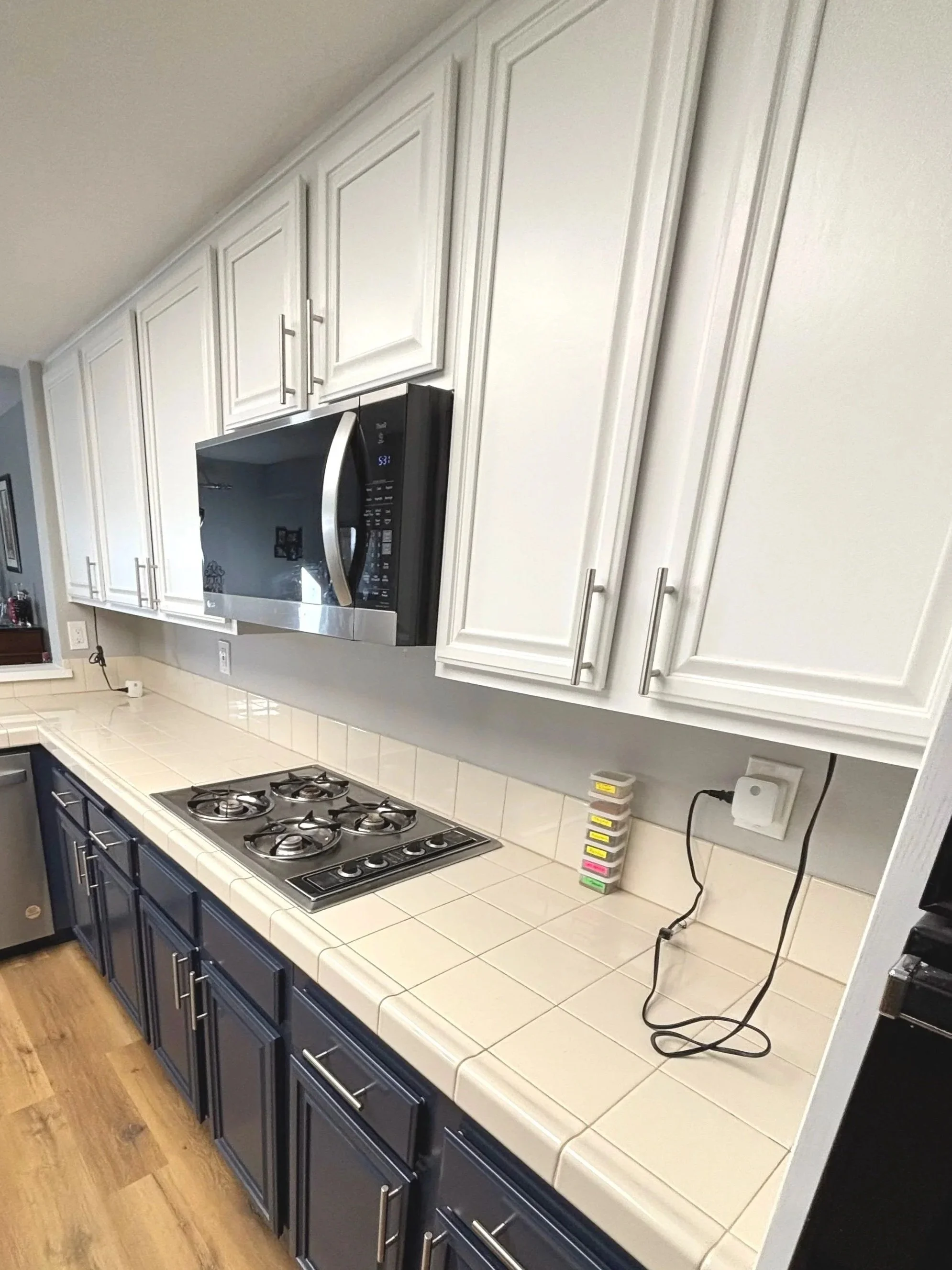 Two-tone cabinet refinishing and painting project including new hinges and handles