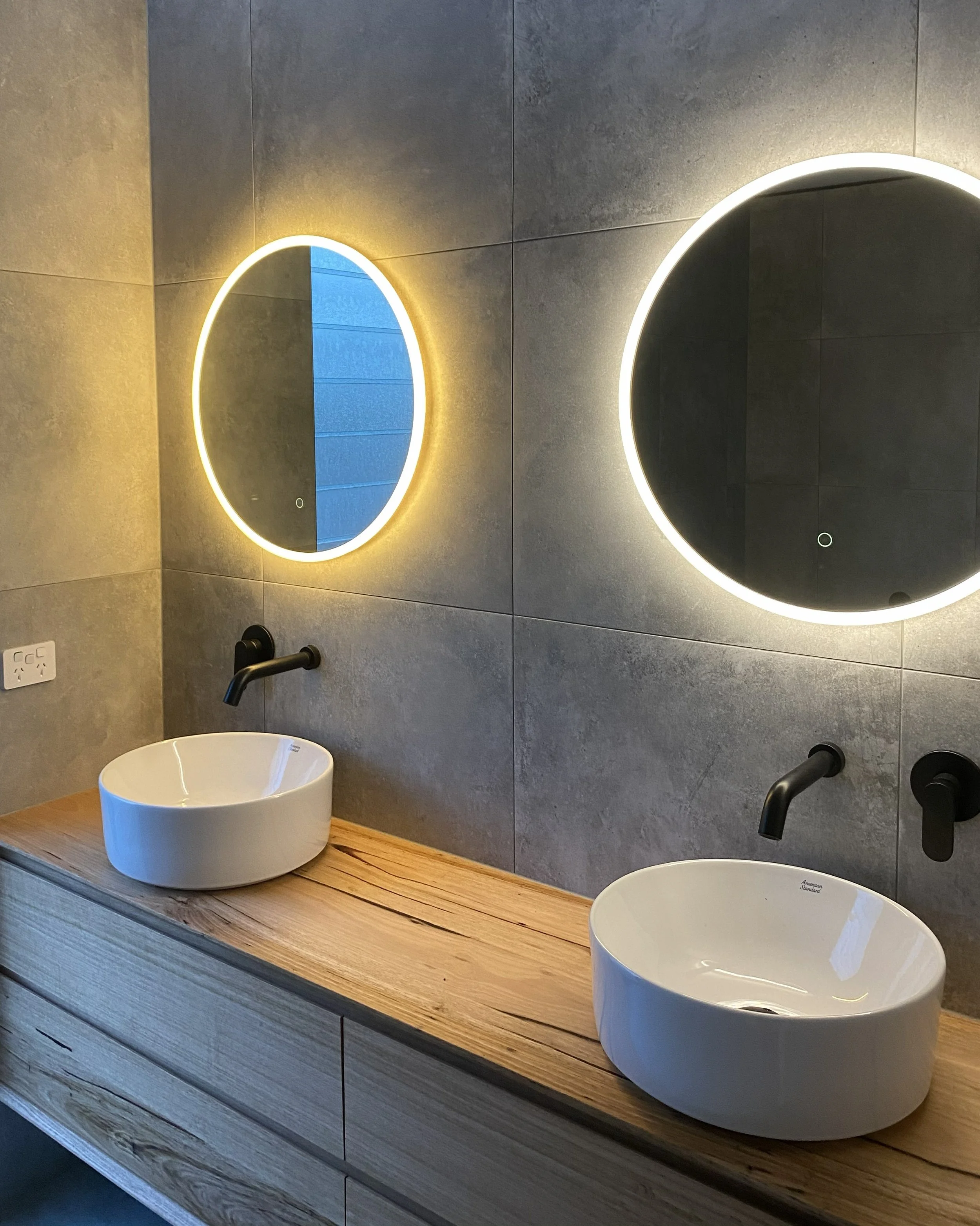 LED mirrors and switches in modern bathroom designed by cowley electrical