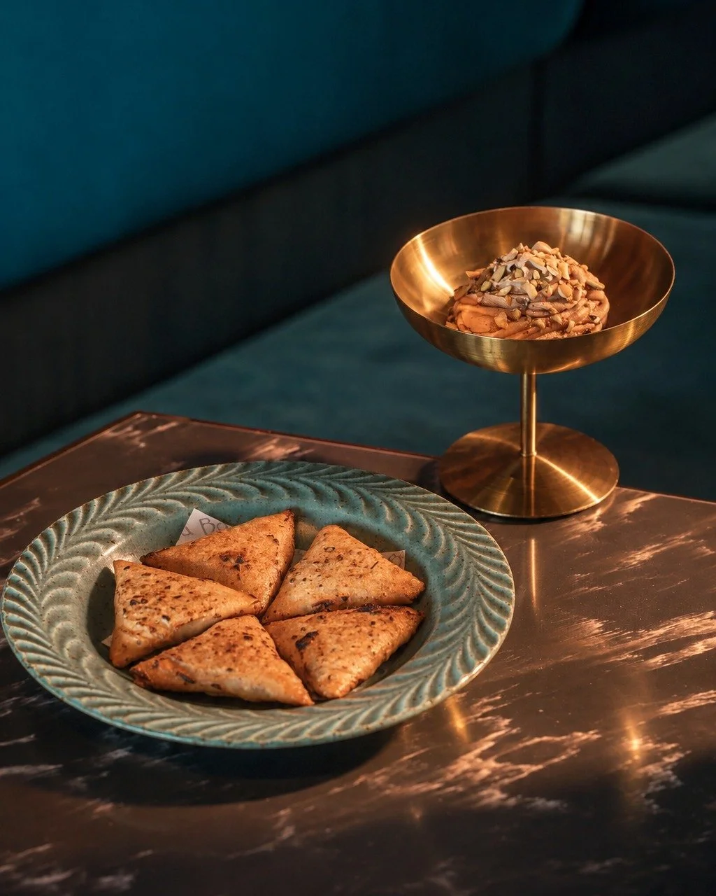 A bite made for sharing.

Crisp duck samosas, golden on the outside and richly savoury within, served with silky whipped foie gras and finished with pistachios for a delicate crunch. Rich, indulgent, and full of flavour.

Make it part of your next me