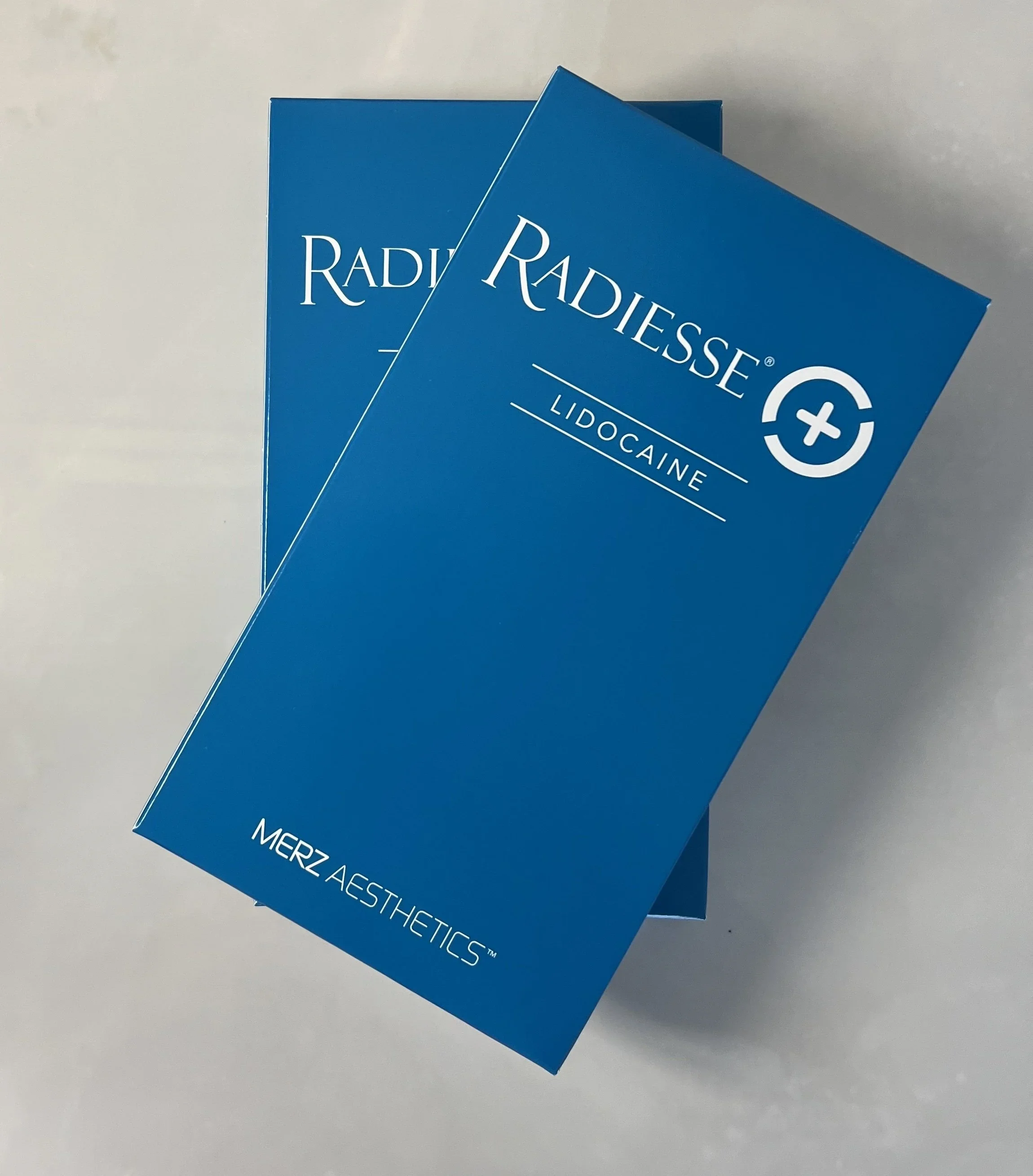 Blue boxes of Radiessence Lidocaine from Merz Aesthetics