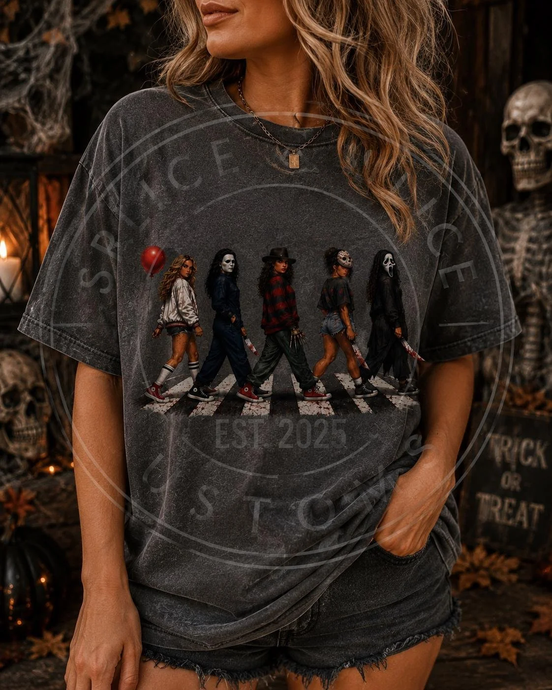 Gray t-shirt featuring a graphic of five women dressed as iconic horror movie villains walking across a crosswalk.