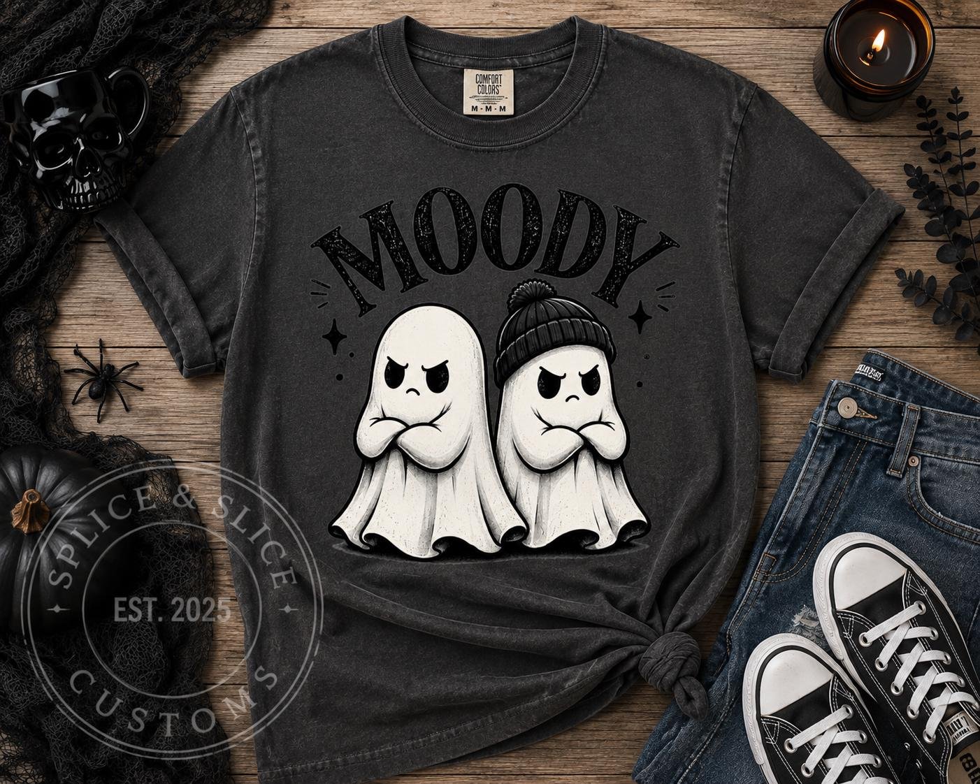 Charcoal gray t-shirt with a graphic of two grumpy ghosts, one wearing a beanie, above the text MOODY.